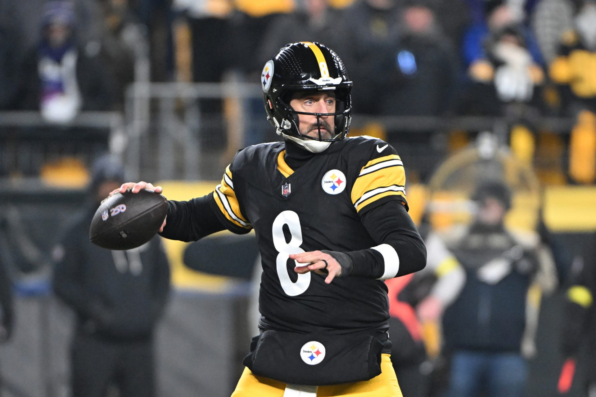 Pittsburgh Steelers quarterback Aaron Rodgers (8) drops back to pass against the Baltimore Ravens during the first half at Acrisure Stadium.