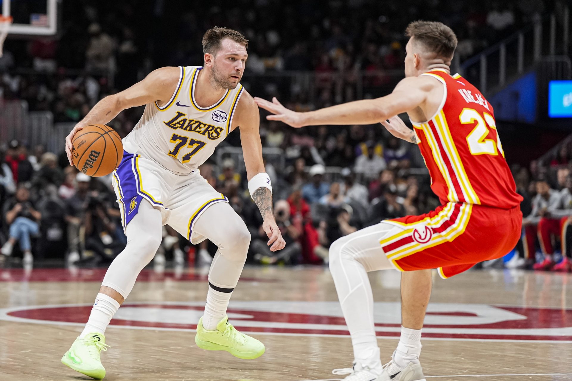 Los Angeles Lakers guard Luka Doncic (77) dribbles guarded by Atlanta Hawks guard Vit Krejci (27) during the first half at State Farm Arena.