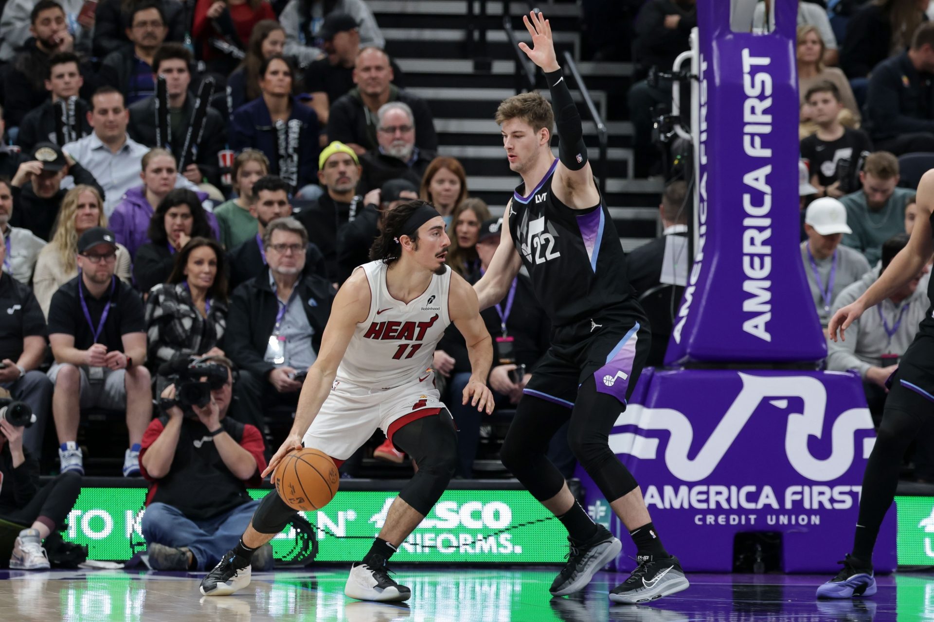 Miami Heat guard Jaime Jaquez Jr. (11) tries to get around Utah Jazz forward Kyle Filipowski (22) and to the basket during the second half at Delta Center.