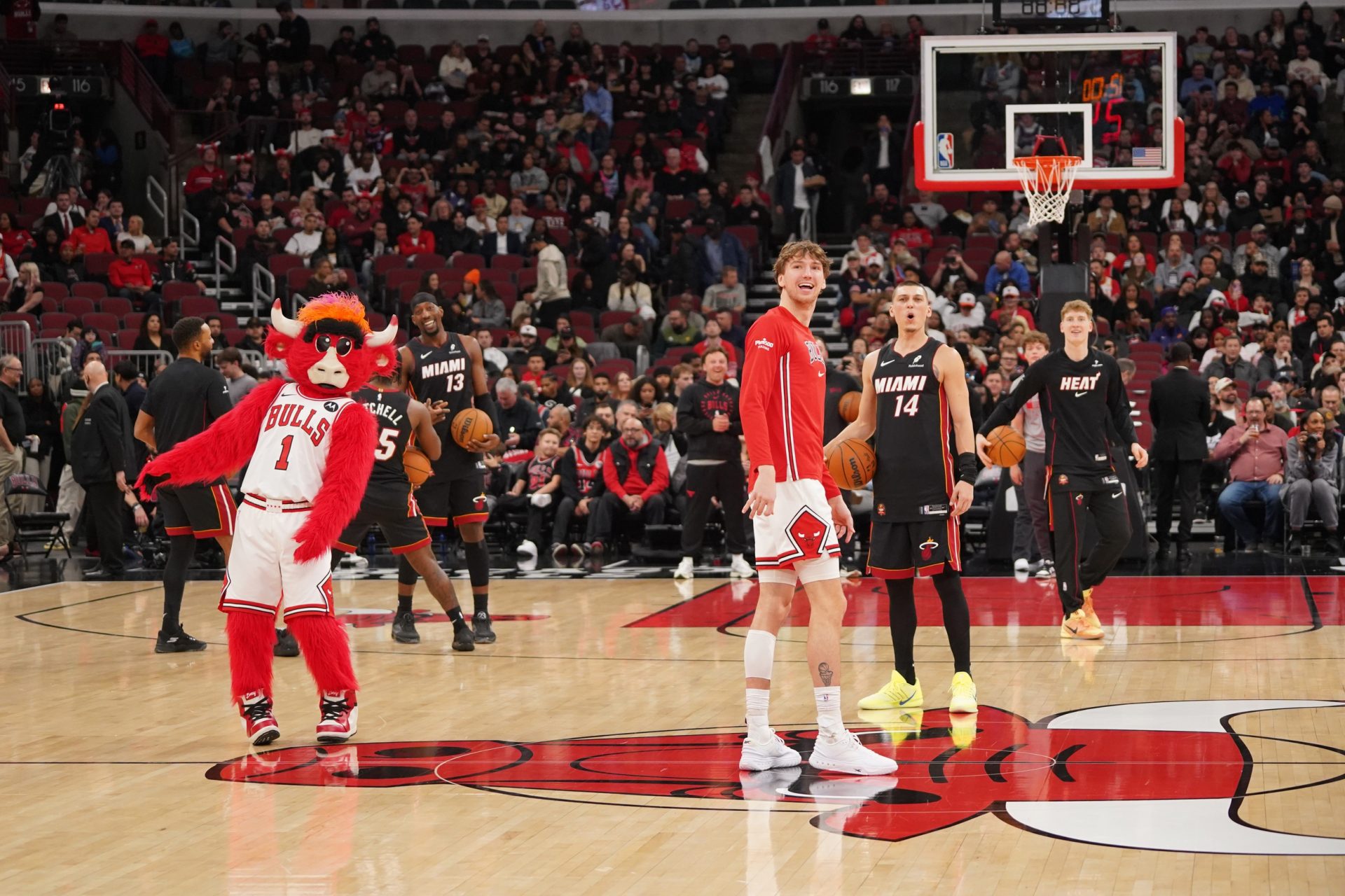 Chicago Bulls forward Matas Buzelis (14) and Miami Heat guard Tyler Herro (14) take backward half courts shots as the game against the Miami Heat is delayed because of condensation on the court due to humidity and rain at United Center.