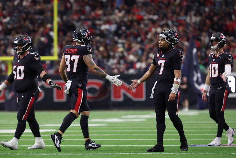 Houston Texans quarterback C.J. Stroud (7) high-fives tight end Cade Stover (87) during the second quarter against the Arizona Cardinals at NRG Stadium.