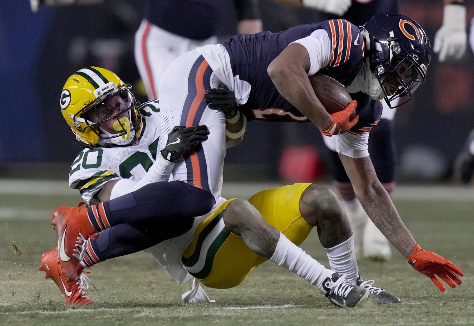 Green Bay Packers safety Javon Bullard (20) tackles Chicago Bears wide receiver DJ Moore (2) during the fourth quarter of their game Saturday, December 20, 2025 at Soldier Field in Chicago, Illinois. The Chicago Bears beat the Green Bay Packers 22-16 in overtime.