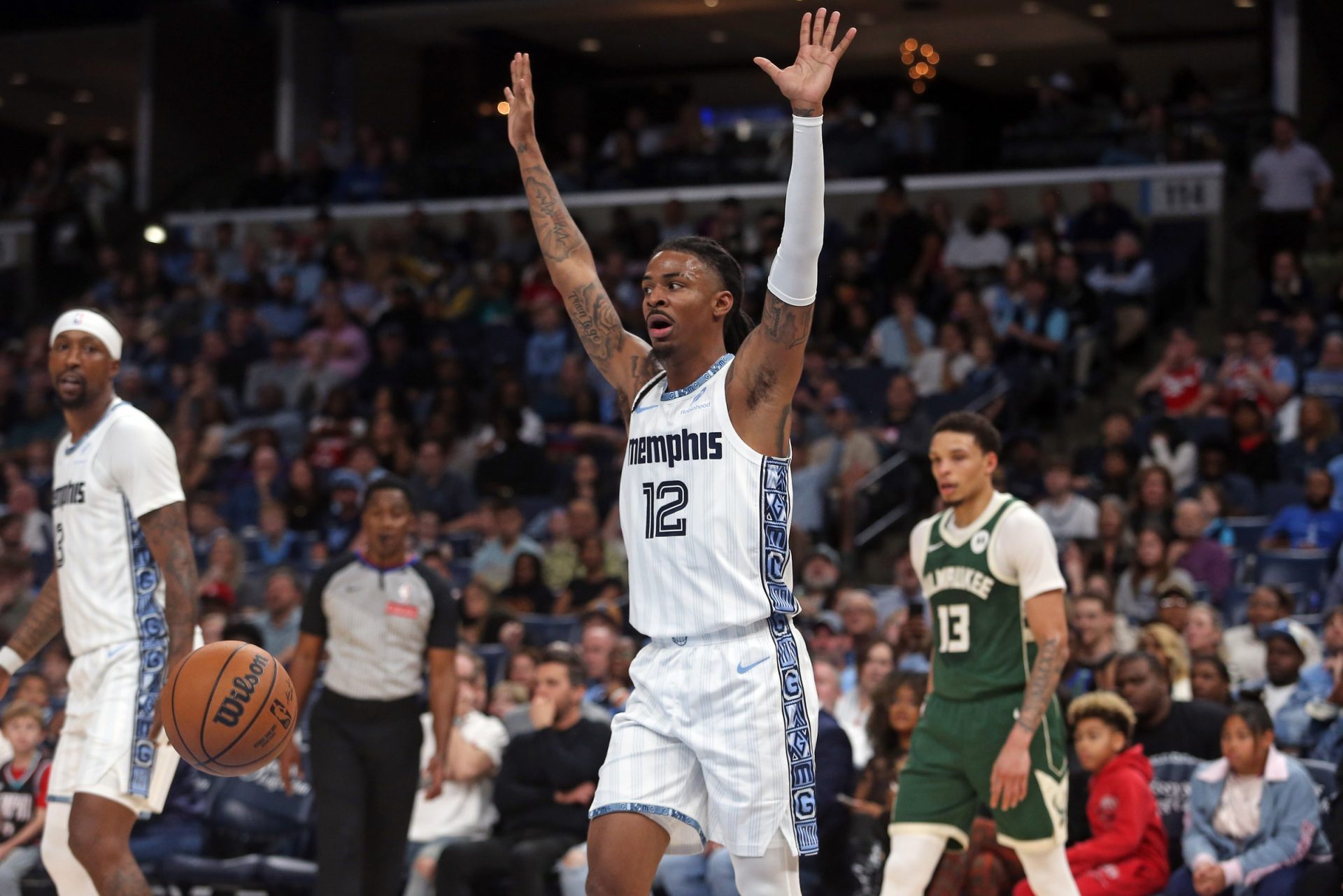 Memphis Grizzlies guard Ja Morant (12) reacts after a foul call during the second quarter against the Milwaukee Bucks at FedExForum.