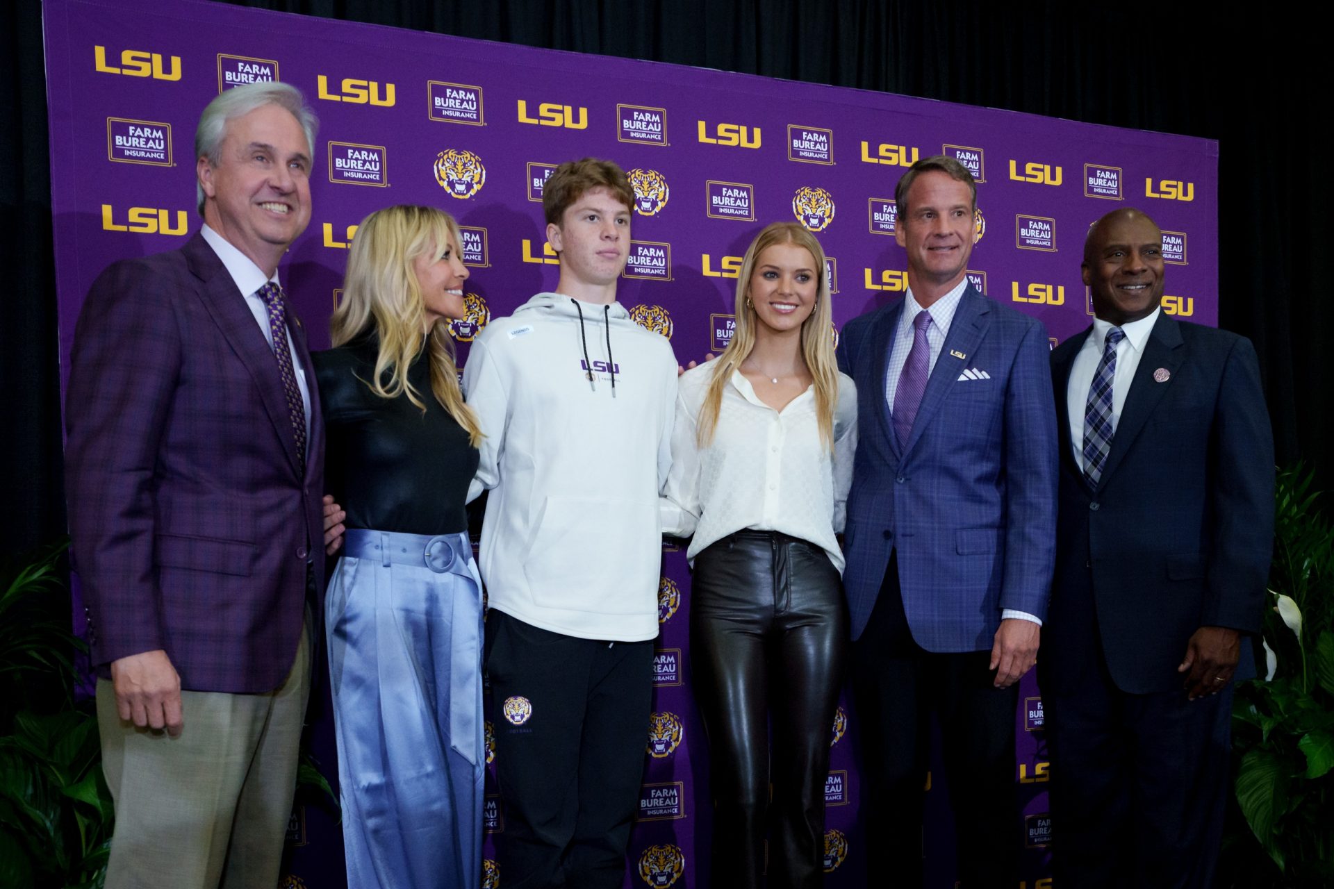 LSU new head coach Lane Kiffin, second right, stands with his family including daughter Landry, son Knox,  ex-wife Layla Kiffin, second left, LSU president Wade Rousse, left, and LSU athletic director Verge Ausberry, right, at South Stadium Club at Tiger Stadium.