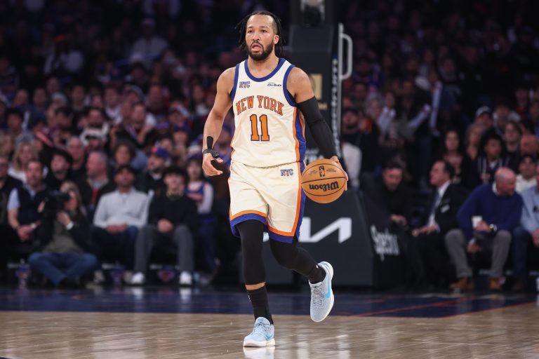 New York Knicks guard Jalen Brunson (11) brings the ball up the court in the first quarter against the Philadelphia 76ers at Madison Square Garden.