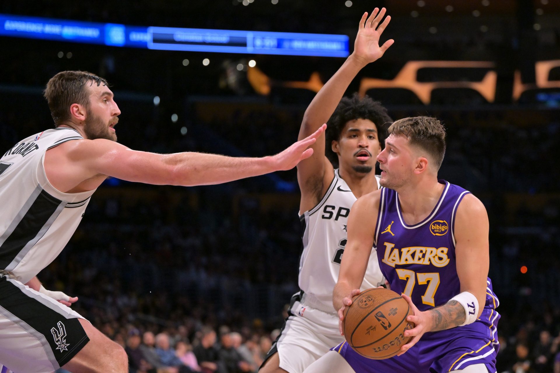 Los Angeles Lakers guard Luka Doncic (77) is defended by San Antonio Spurs center Luke Kornet (7) and guard Dylan Harper (2) during the second half at Crypto.com Arena.
