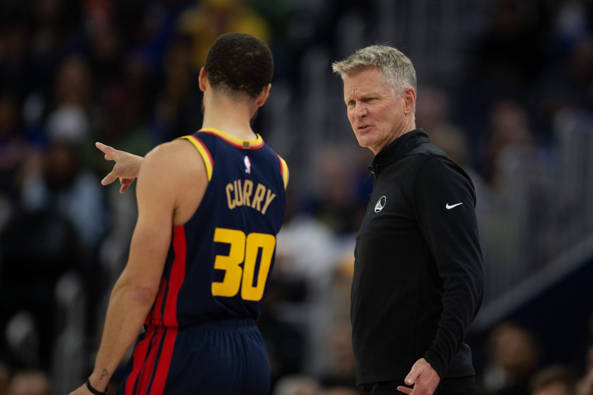 Golden State Warriors head coach Steve Kerr confers with guard Stephen Curry (30)  during the second quarter against the Sacramento Kings at Chase Center.