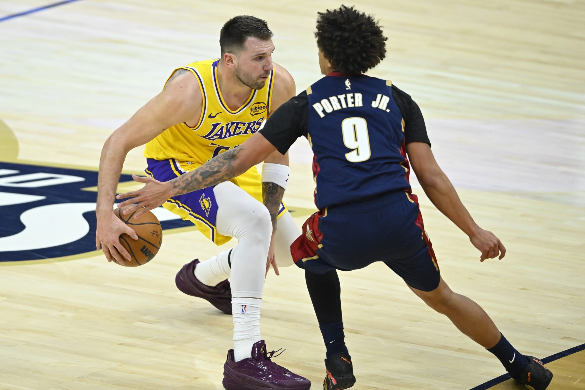 Los Angeles Lakers guard Luka Doncic (77) dribbles beside Cleveland Cavaliers guard Craig Porter Jr. (9) in the second quarter at Rocket Arena.