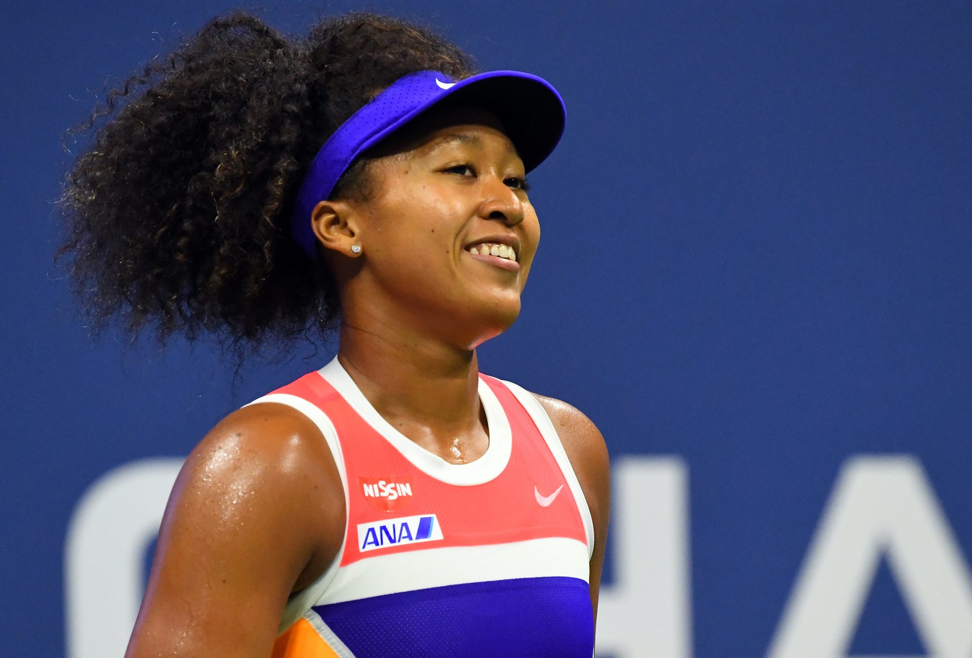 Naomi Osaka of Japan smiles between serves against Jennifer Brady of the United States in the women's singles semifinals match on day eleven of the 2020 U.S. Open tennis tournament at USTA Billie Jean King National Tennis Center.