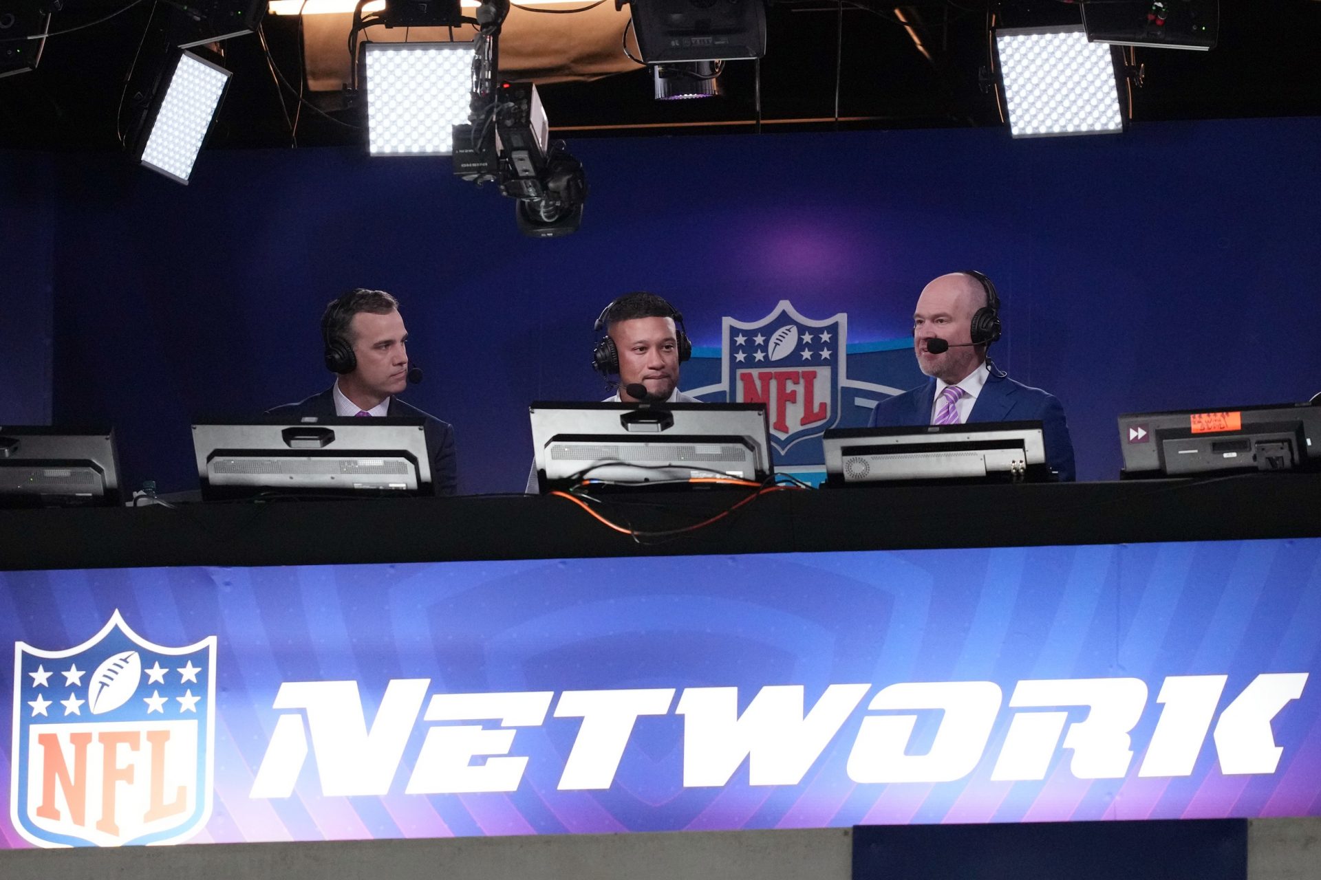 Left to right: NFL broadcasters Daniel Jeremiah, Marcus Robinson, and Rich Eisen in the NFL Network booth during the 2024 NFL Combine at Lucas Oil Stadium.