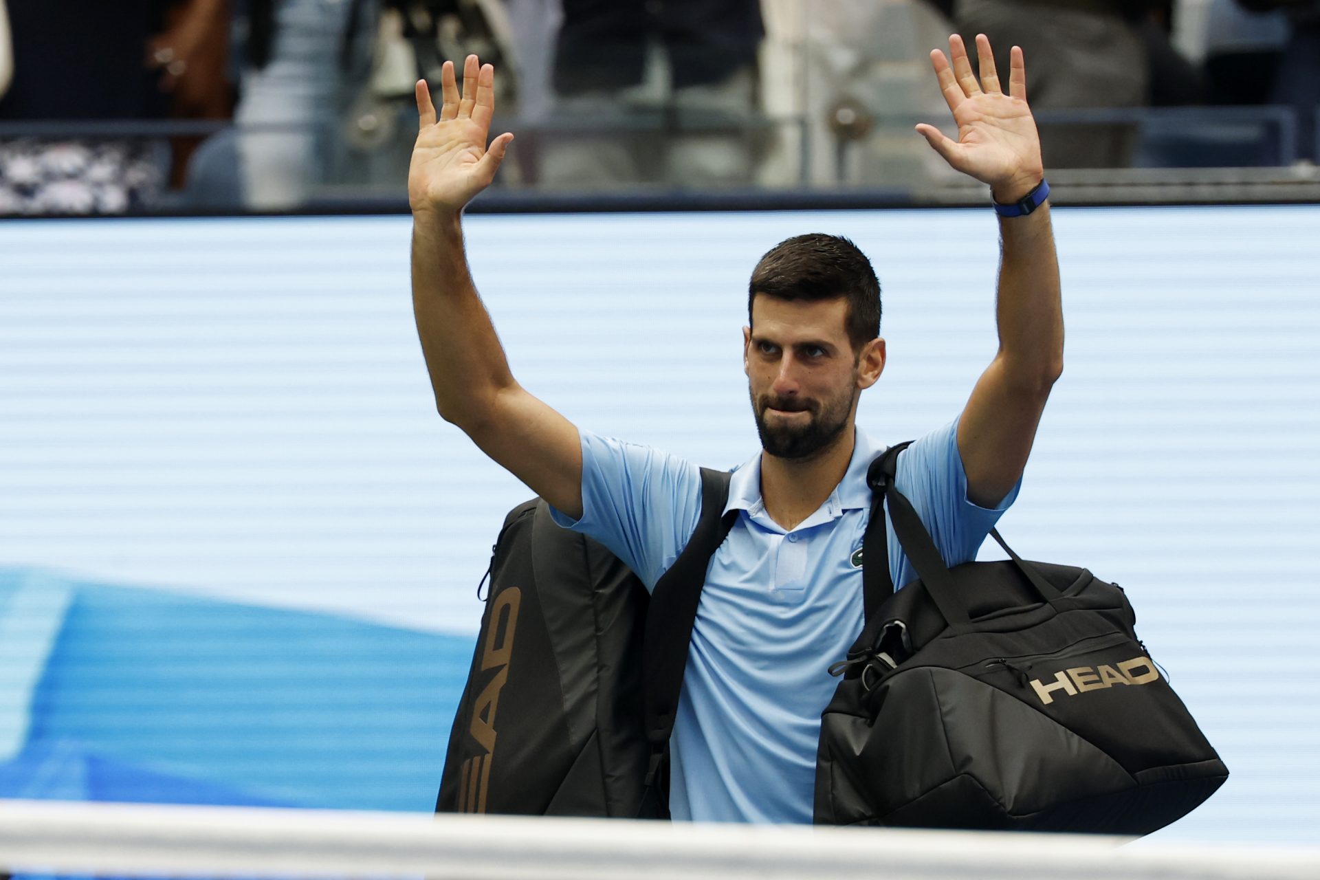 Novak Djokovic (SRB) waves to the crowd while leaving the court after his match against Carlos Alcaraz (ESP) (not pictured) in a men's singles semifinal on day thirteen of the 2025 US Open tennis championships at USTA Billie Jean King National Tennis Center.