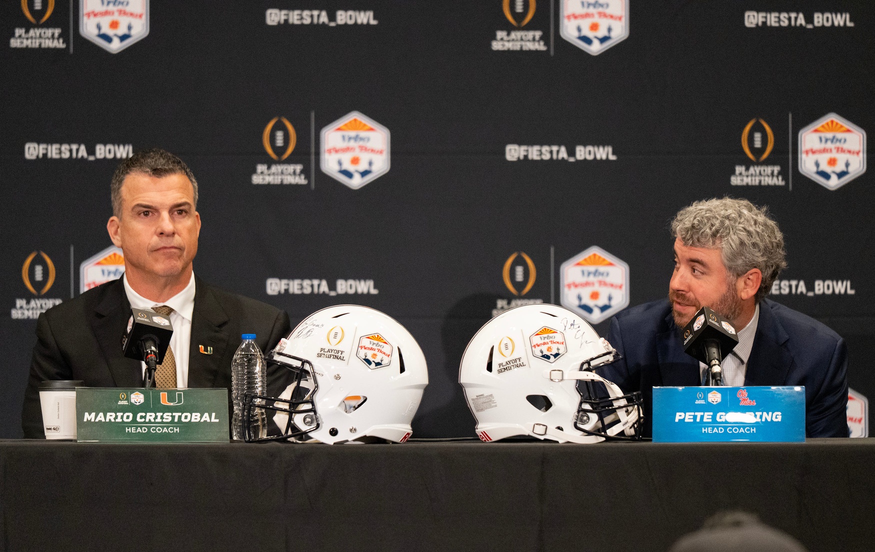 Ole Miss Head Coach Pete Golding looks over at Miami Head Coach Mario Cristobal during a CFP and Fiesta Bowl press conference at the JW Marriott Scottsdale Camelback Inn Resort & Spa, in Scottsdale, Ariz., on Wednesday, Jan. 7, 2026.
