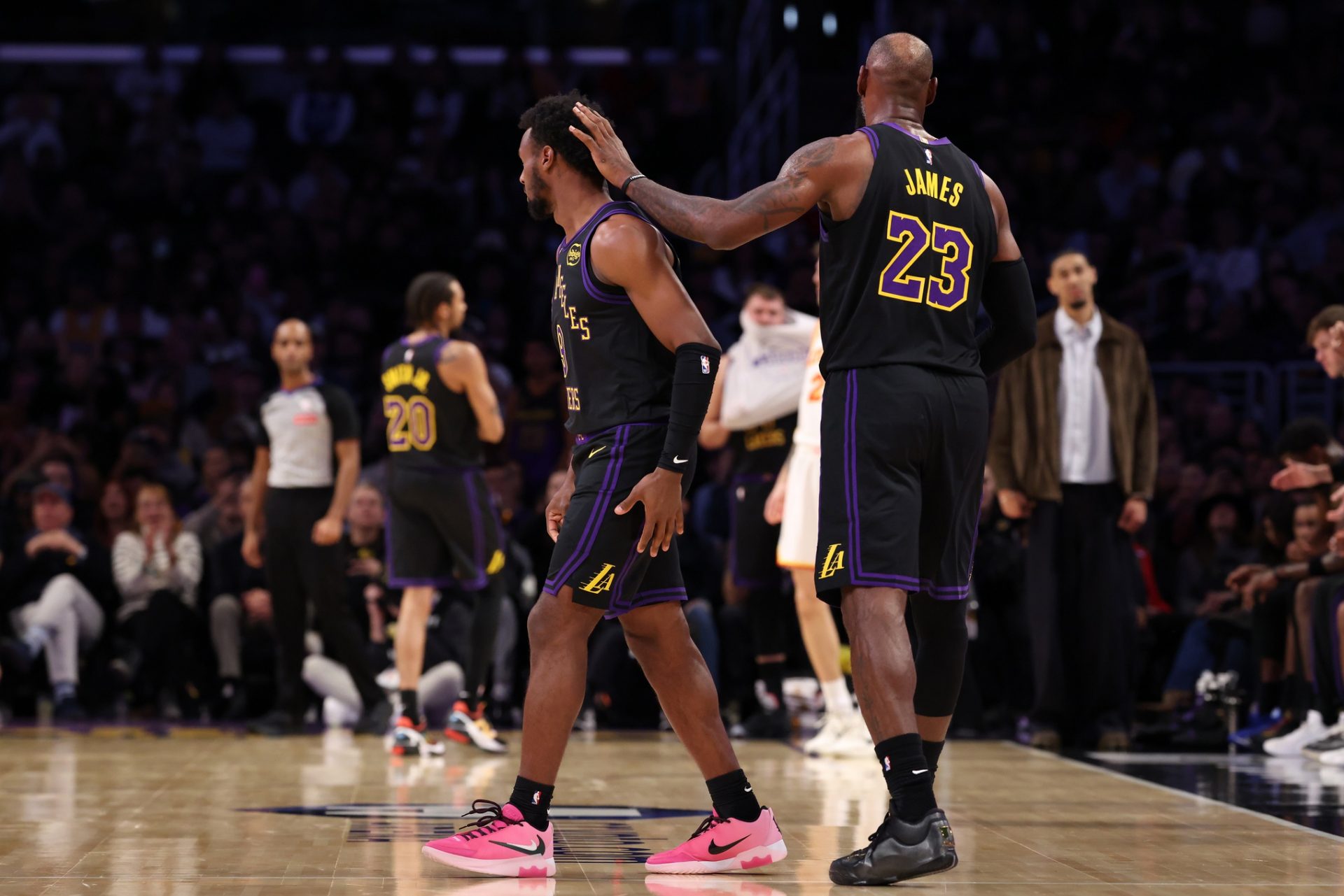 Los Angeles Lakers forward LeBron James (23) greets guard Bronny James (9) as Bronny enters the game for LeBron during the fourth quarter against the Atlanta Hawks at Crypto.com Arena.