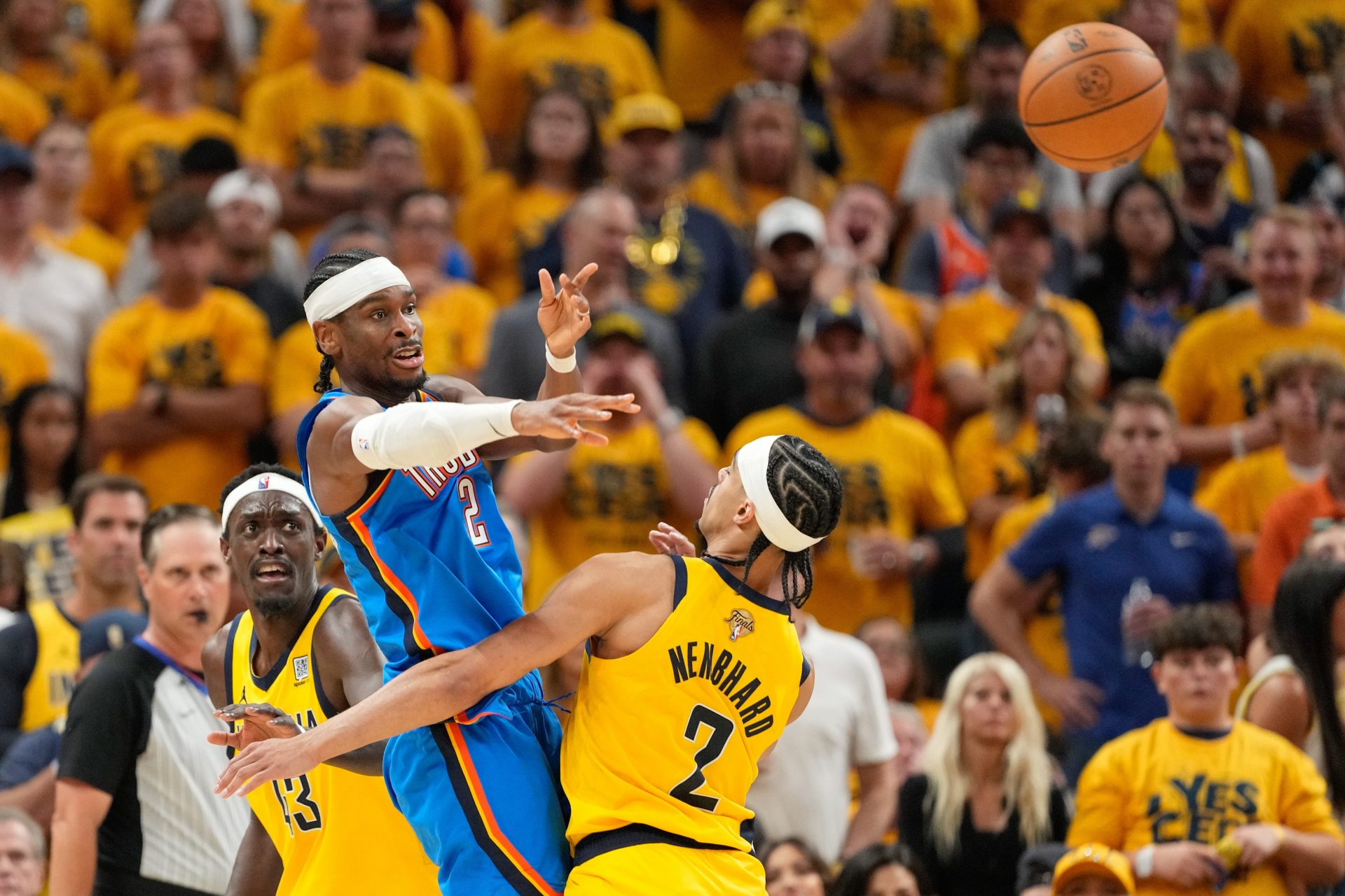 Oklahoma City Thunder guard Shai Gilgeous-Alexander (2) passes the ball defended by Indiana Pacers forward Pascal Siakam (43) and guard Andrew Nembhard (2) in the third quarter during game six of the 2025 NBA Finals at Gainbridge Fieldhouse.