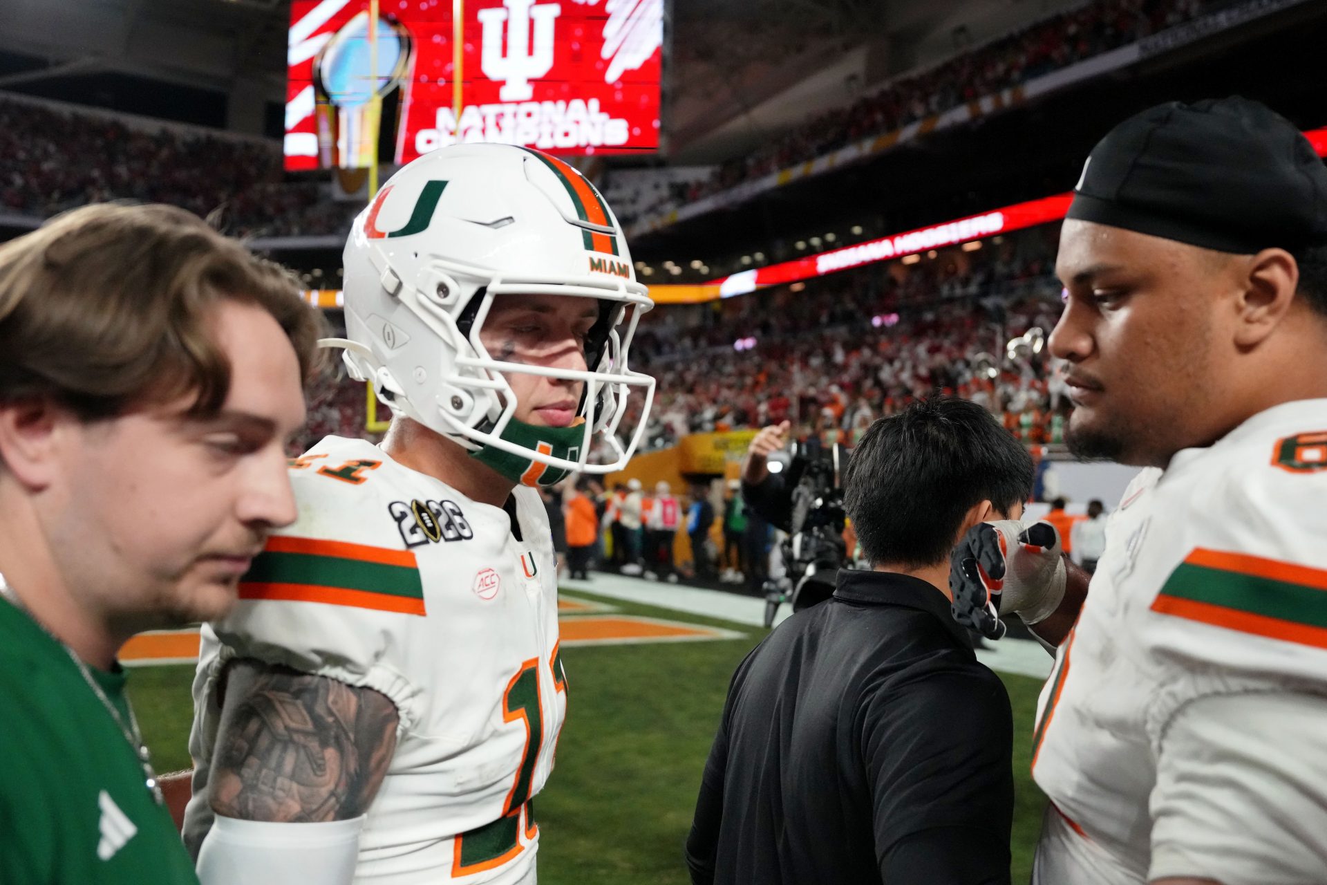 Miami Hurricanes quarterback Carson Beck (11) and offensive lineman Francis Mauigoa (61) react after losing to Indiana Hoosiers inthe College Football Playoff National Championship game at Hard Rock Stadium.