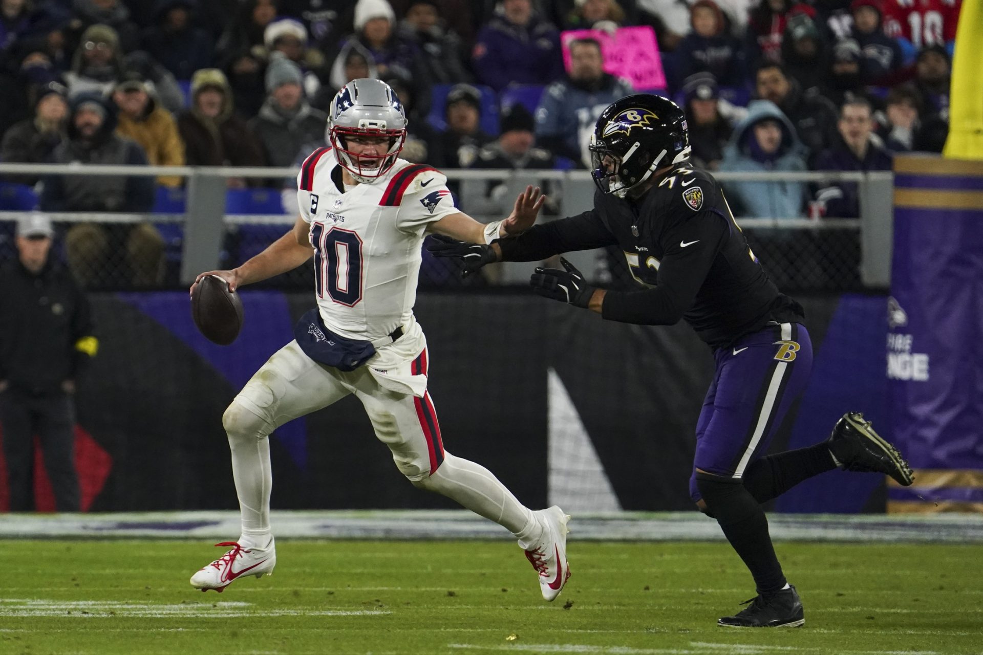 New England Patriots quarterback Drake Maye (10) runs from Baltimore Ravens linebacker Kyle van Noy (53) 
Source: Imagn