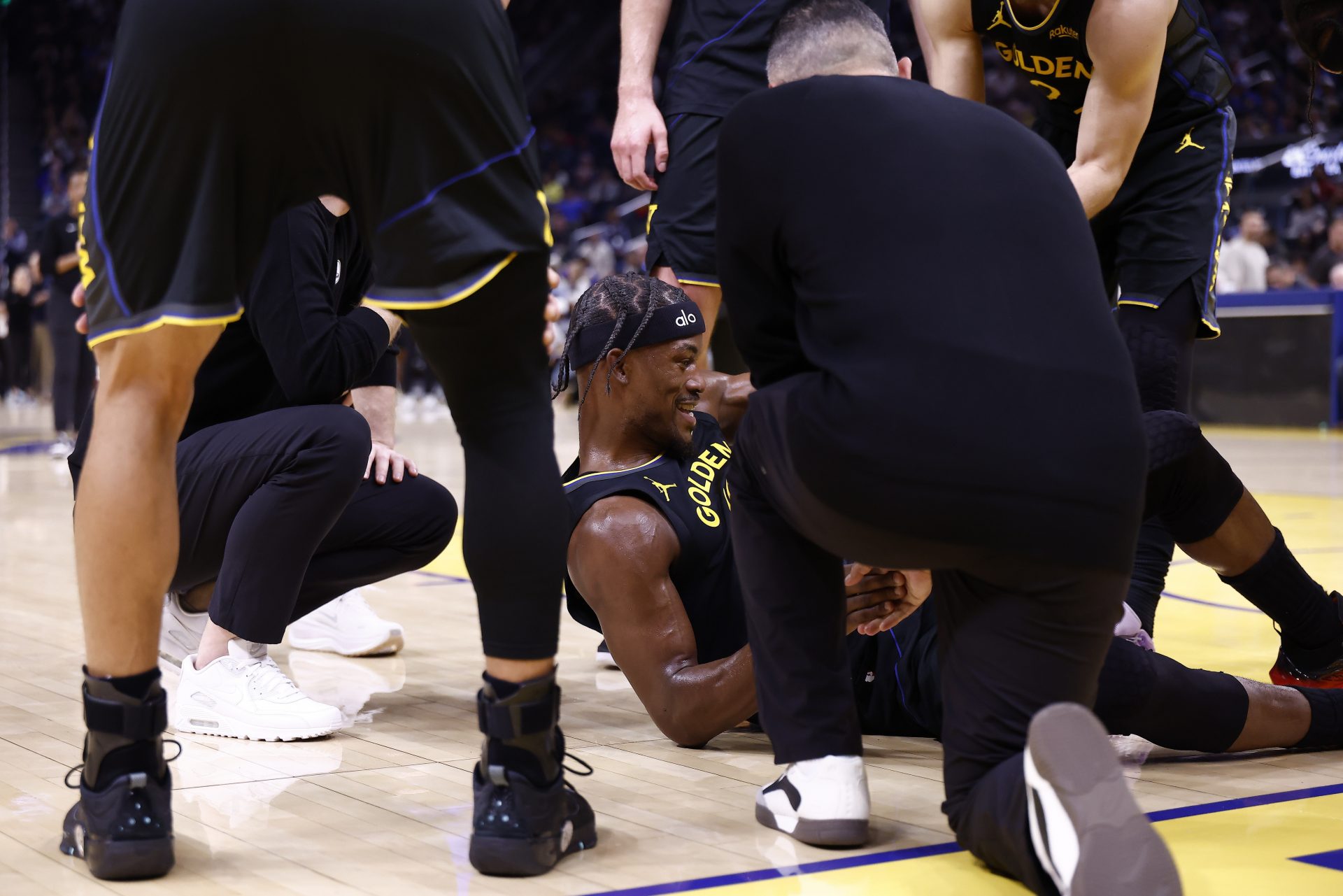 Golden State Warriors forward Jimmy Butler III (10) is helped up after going down with a knee injury during the third quarter against the Miami Heat at Chase Center.
