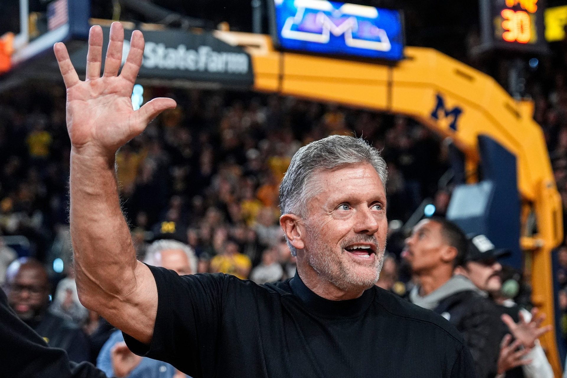 Michigan football head coach Kyle Whittingham waves at the crowd as he is being introduced on the floor during the first half between Michigan and USC at Crisler Center in Ann Arbor on Friday, Jan. 2, 2026.