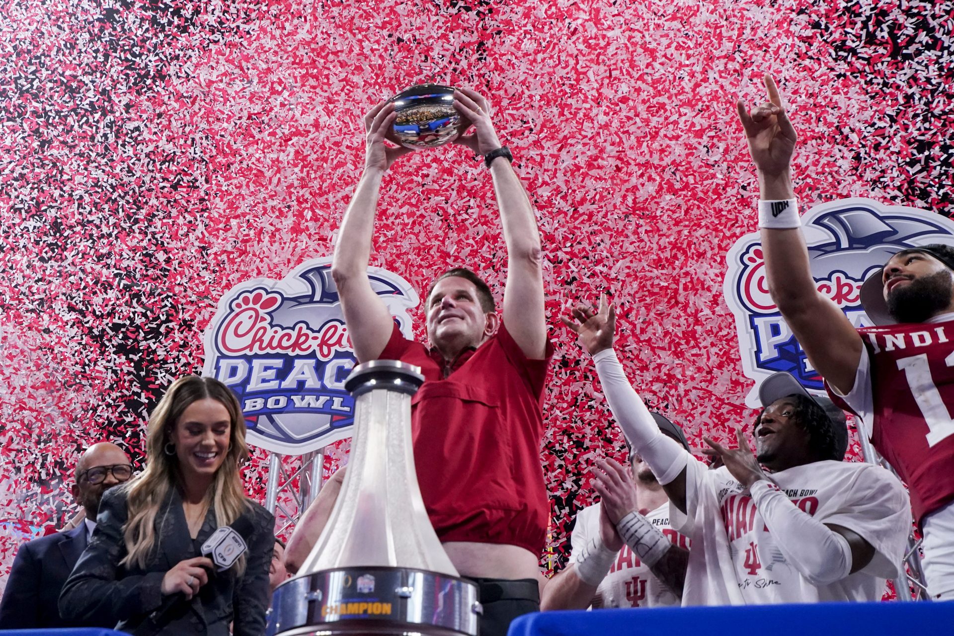 Indiana Hoosiers head coach Curt Cignetti holds up the trophy as confetti falls Friday, Jan. 9, 2026, after defeating the Oregon Ducks in the Peach Bowl and semifinal game of the College Football Playoff at Mercedes-Benz Stadium in Atlanta.