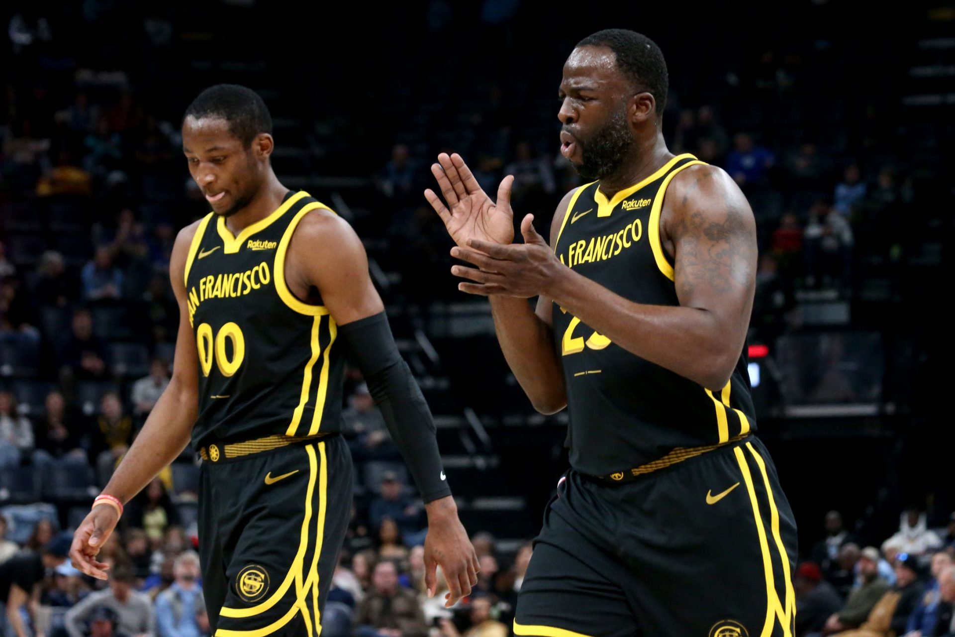 Golden State Warriors forward Jonathan Kuminga (00) and Golden State Warriors forward Draymond Green (23) walk to the bench at the end of the first quarter against the Memphis Grizzlies  at FedExForum.