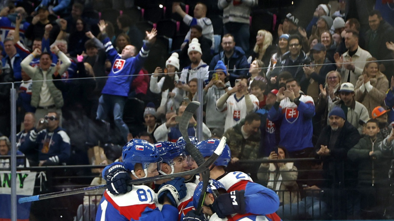 Adam Ruzicka of Slovakia celebrates scoring their fourth goal with teammates against Finland in men's ice hockey group B play during the Milano Cortina 2026 Olympic Winter Games at Milano Santagiulia Ice Hockey Arena.