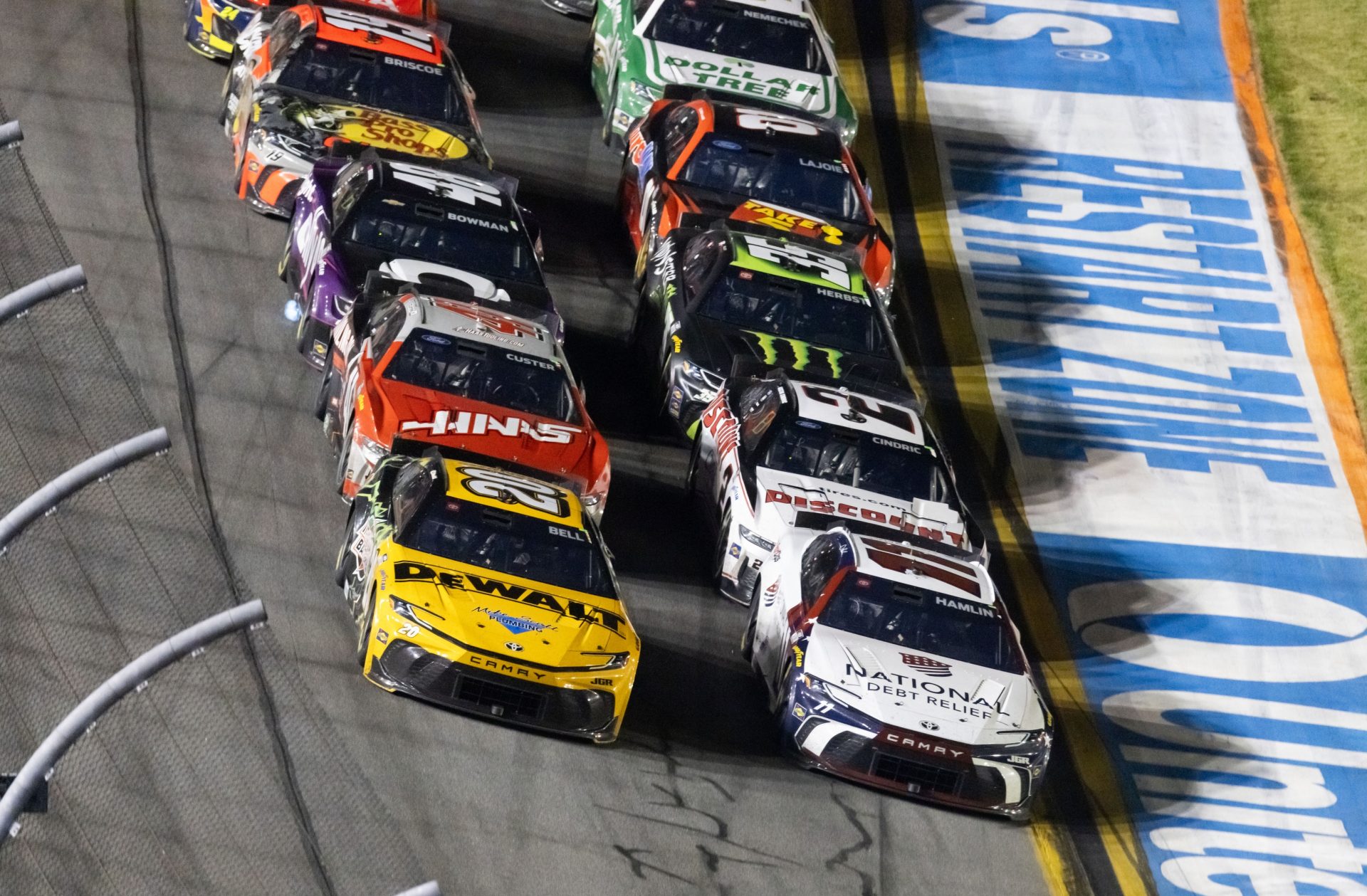 NASCAR Cup Series driver Christopher Bell (20) races alongside Denny Hamlin (11) for the lead during the Daytona 500 at Daytona International Speedway.