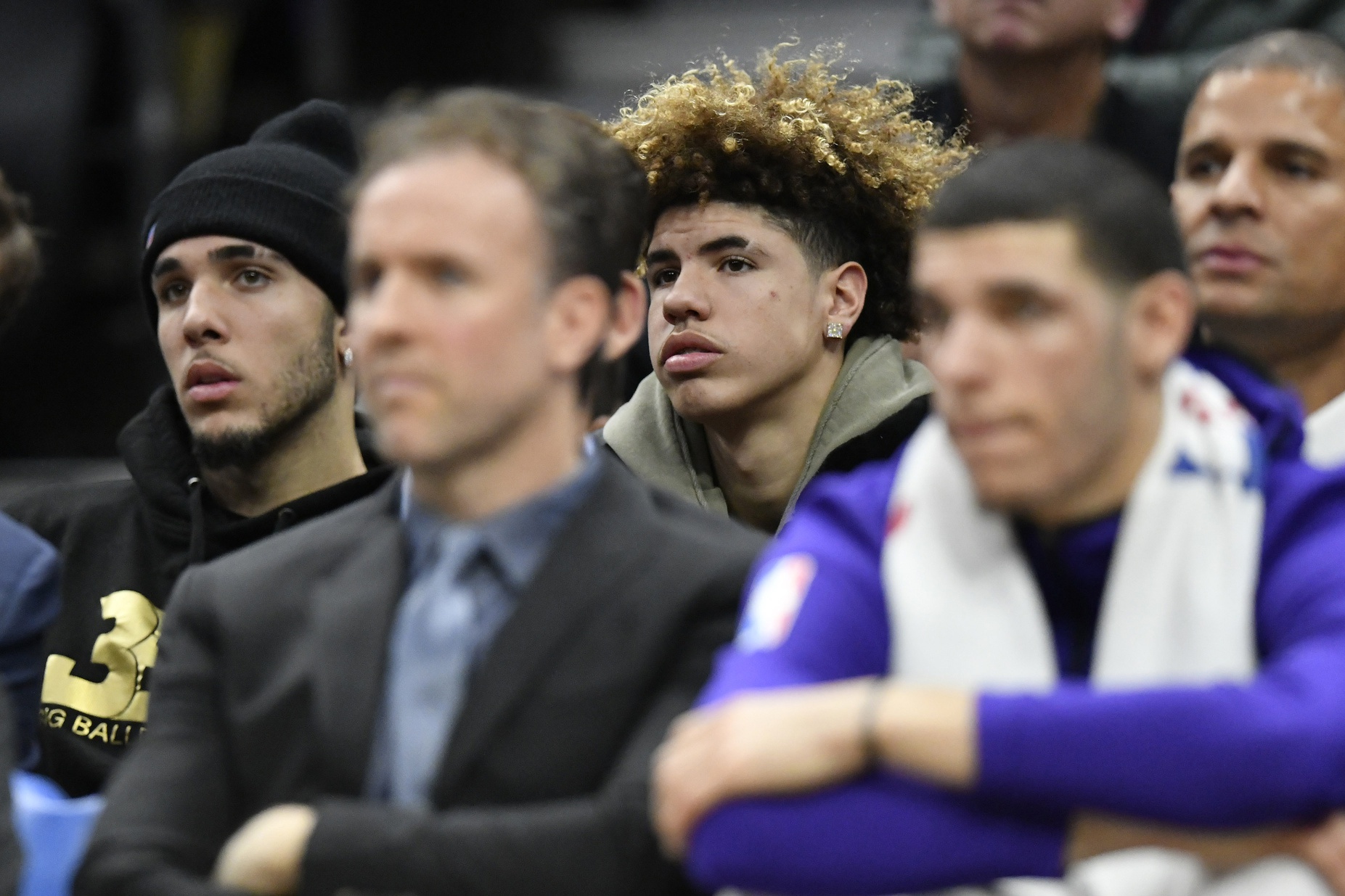 LiAngelo Ball, back left, and LaMelo Ball sit behind their brother, Los Angeles Lakers guard Lonzo Ball, front right, during a game between the Cleveland Cavaliers and the Los Angeles Lakers at Quicken Loans Arena.