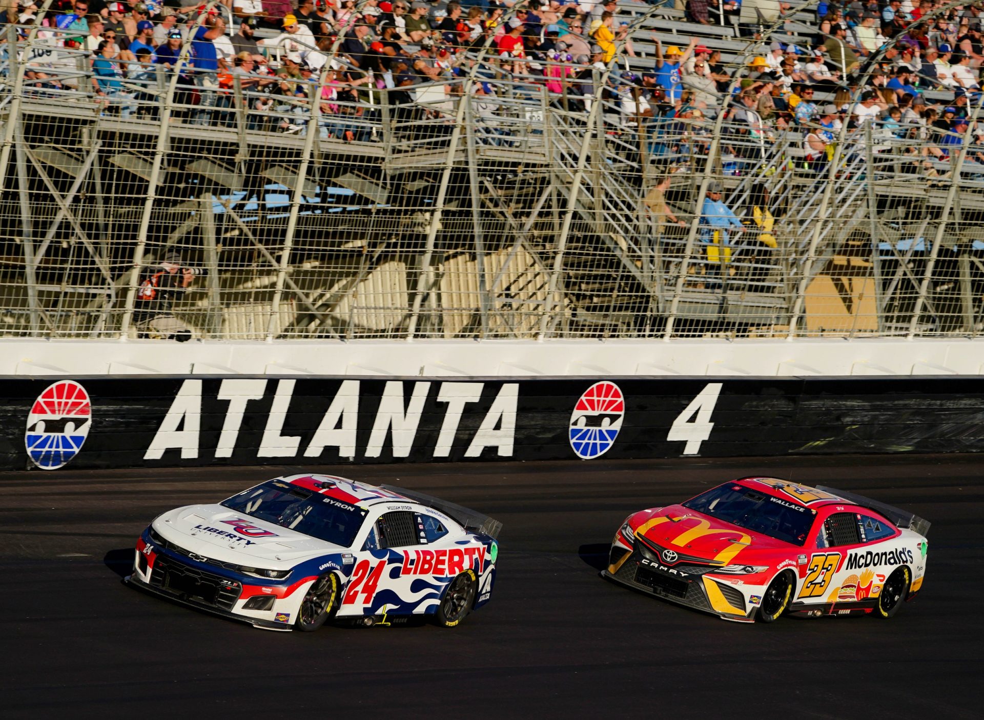 NASCAR Cup Series driver William Byron (24) and NASCAR Cup Series driver Bubba Wallace (23) races out of turn four in the Folds of Honor QuikTrip 500 at Atlanta Motor Speedway.