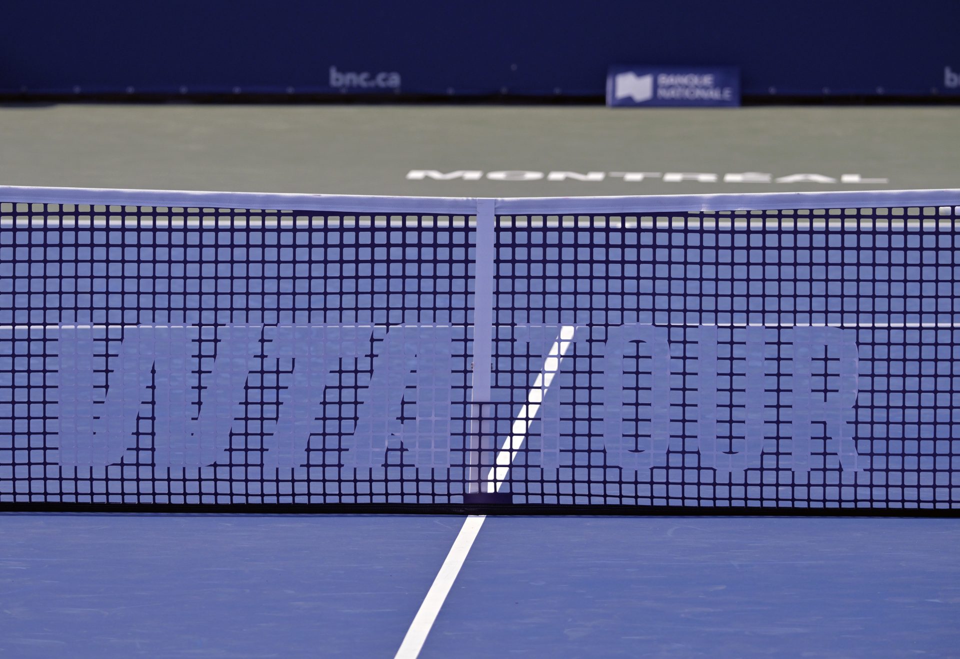 WTA sign on a tennis net in first round play at IGA Stadium.