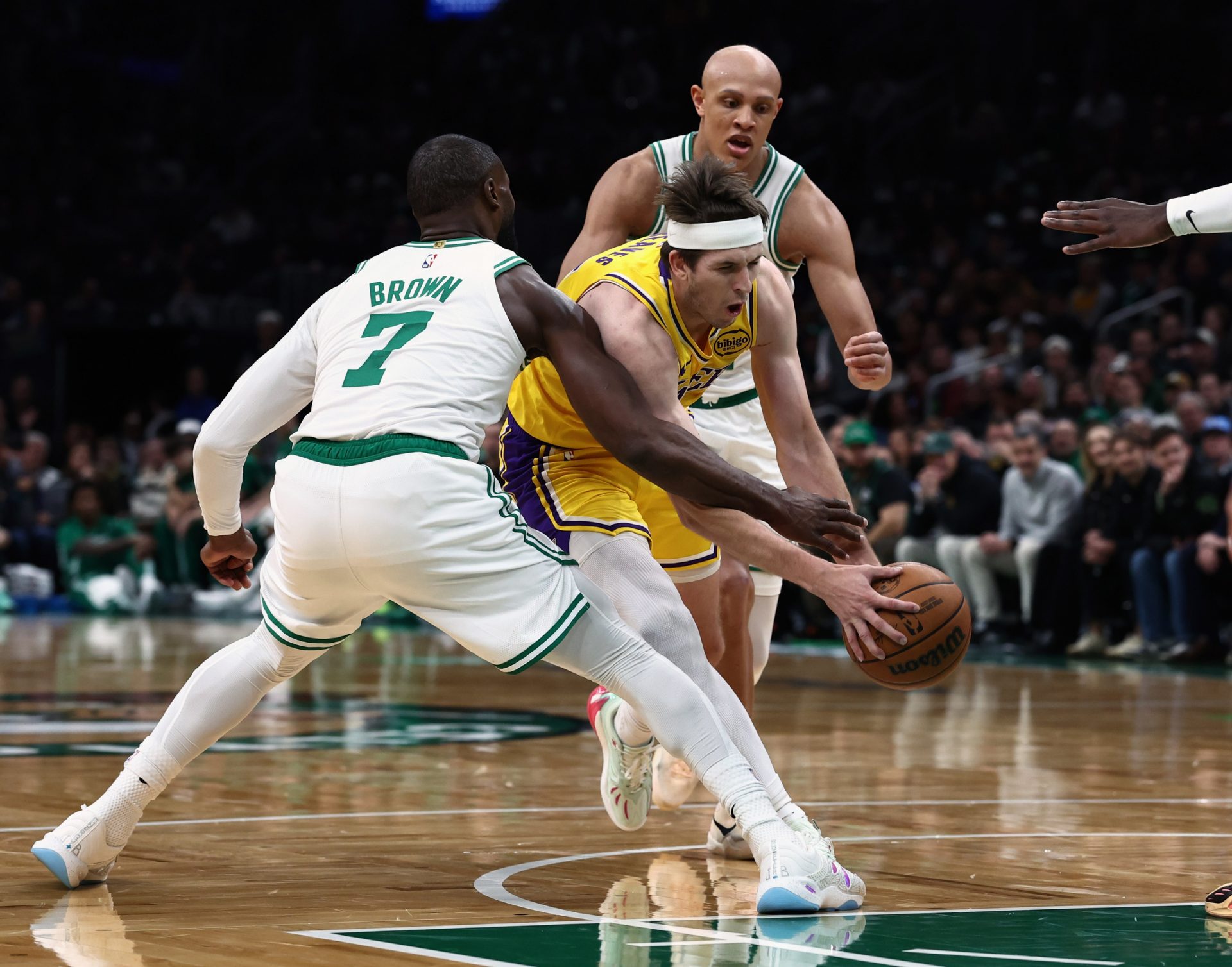 Los Angeles Lakers guard Austin Reaves (15) tries to get past Boston Celtics guard Jaylen Brown (7) during the first quarter at TD Garden.
