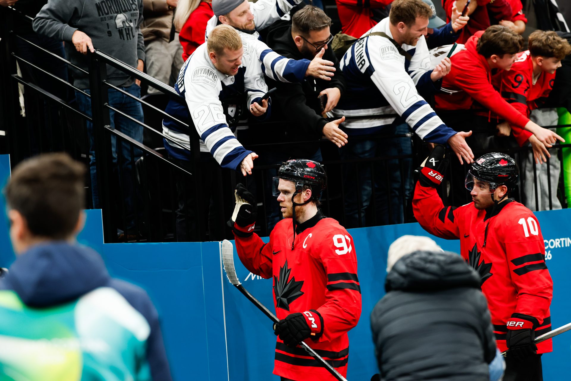 Connor McDavid (97) of Canada greets fans after the game against Finland in a men's ice hockey semifinal during the Milano Cortina 2026 Olympic Winter Games at Milano Santagiulia Ice Hockey Arena.