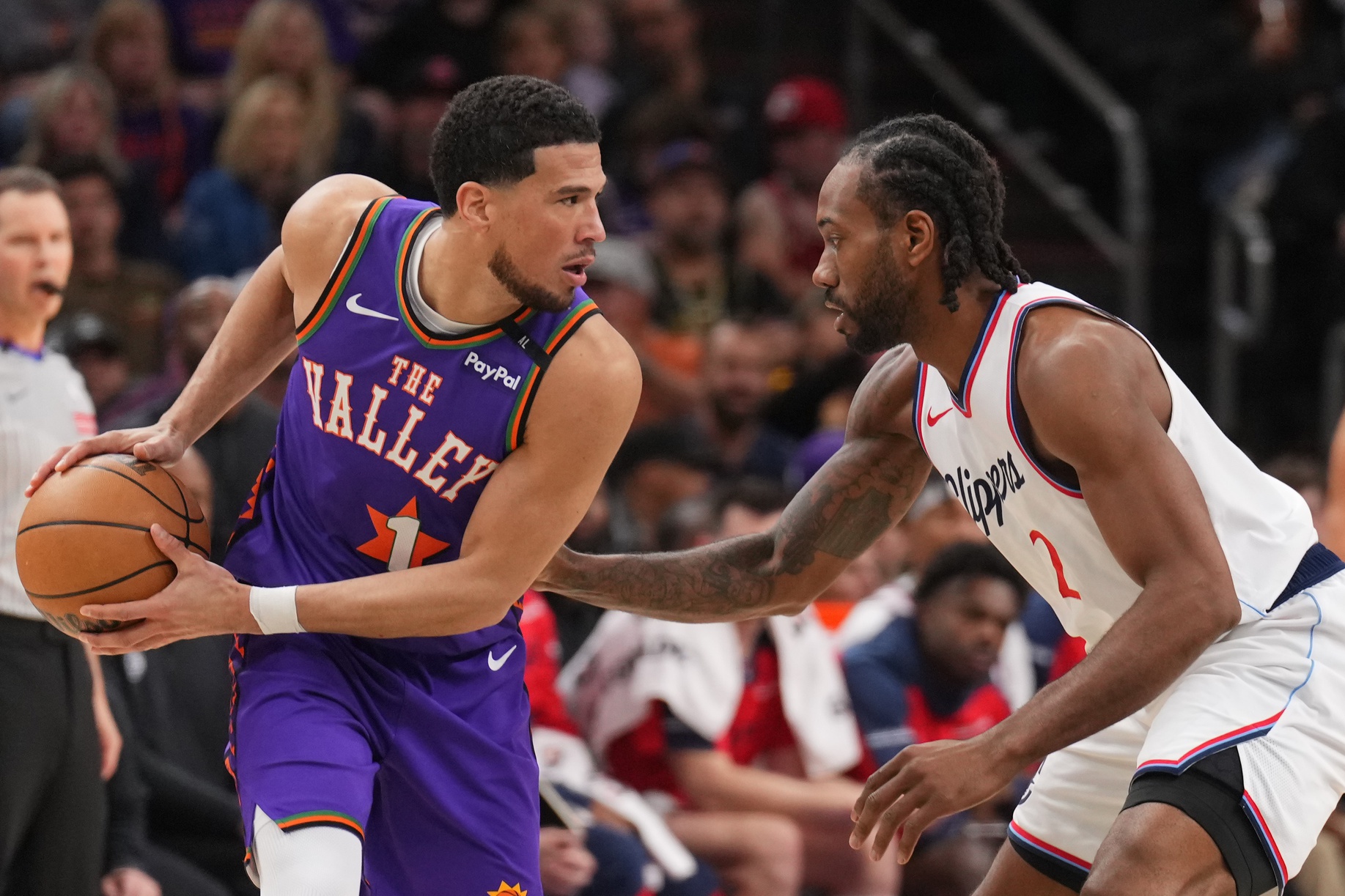 LA Clippers forward Kawhi Leonard (2) guards Phoenix Suns guard Devin Booker (1) during the first half at PHX Center.