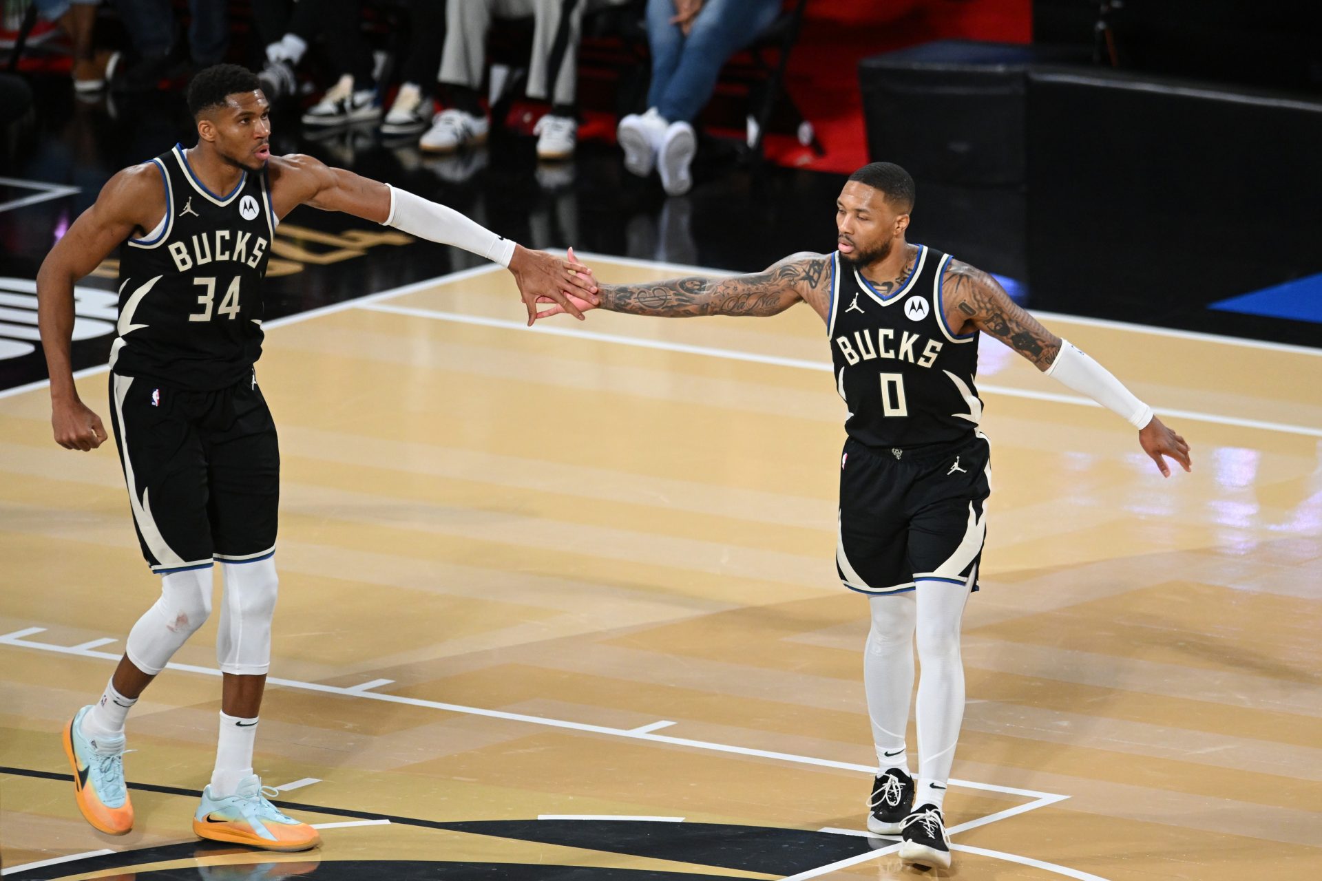 Milwaukee Bucks guard Damian Lillard (0) and forward Giannis Antetokounmpo (34) react during the fourth quarter against the Atlanta Hawks in a semifinal of the 2024 Emirates NBA Cup at T-Mobile Arena.