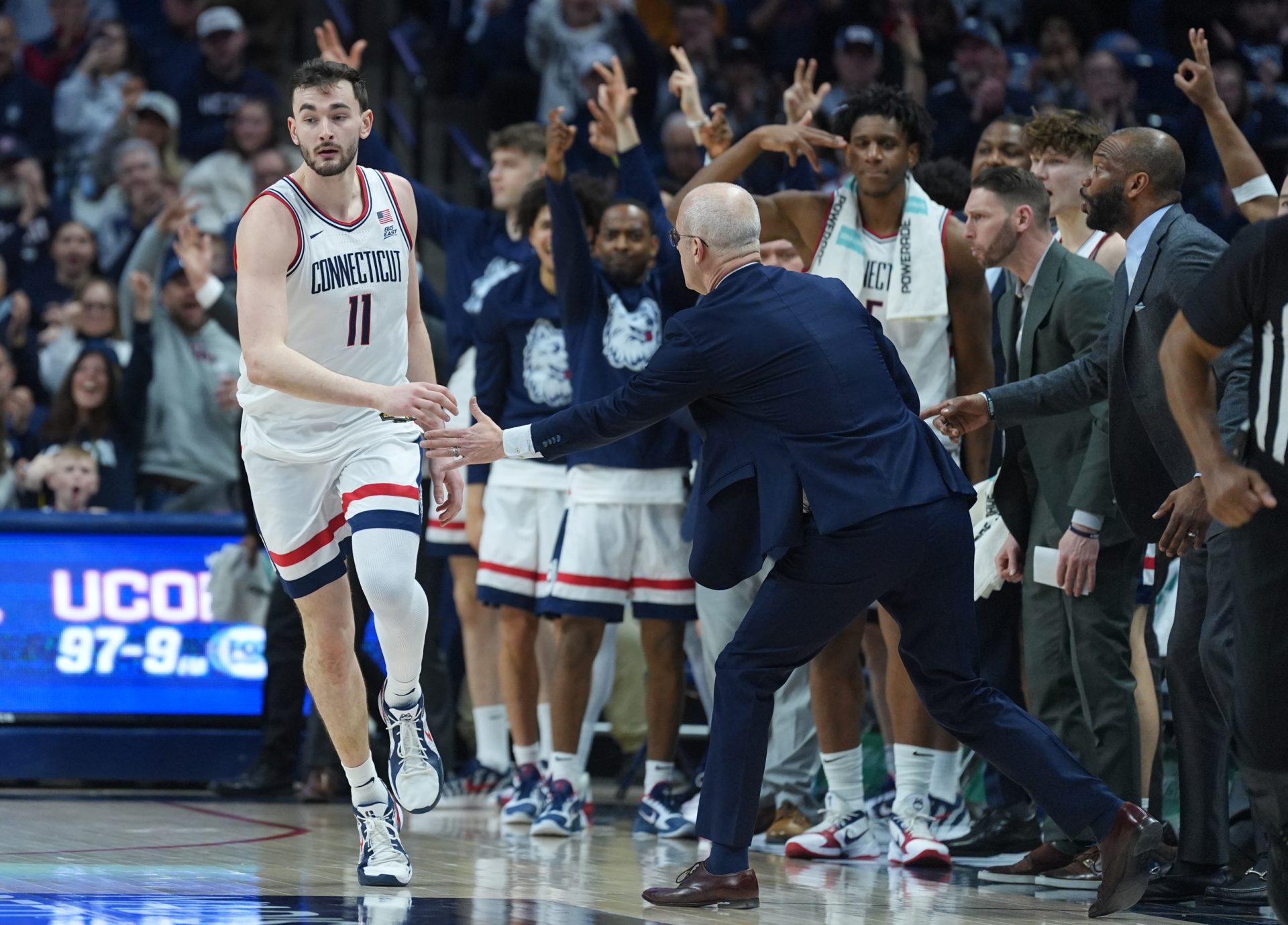 The UConn Huskies bench reacts after forward Alex Karaban (11) makes a three point basket against the Georgetown Hoyas in the second half at Harry A. Gampel Pavilion.