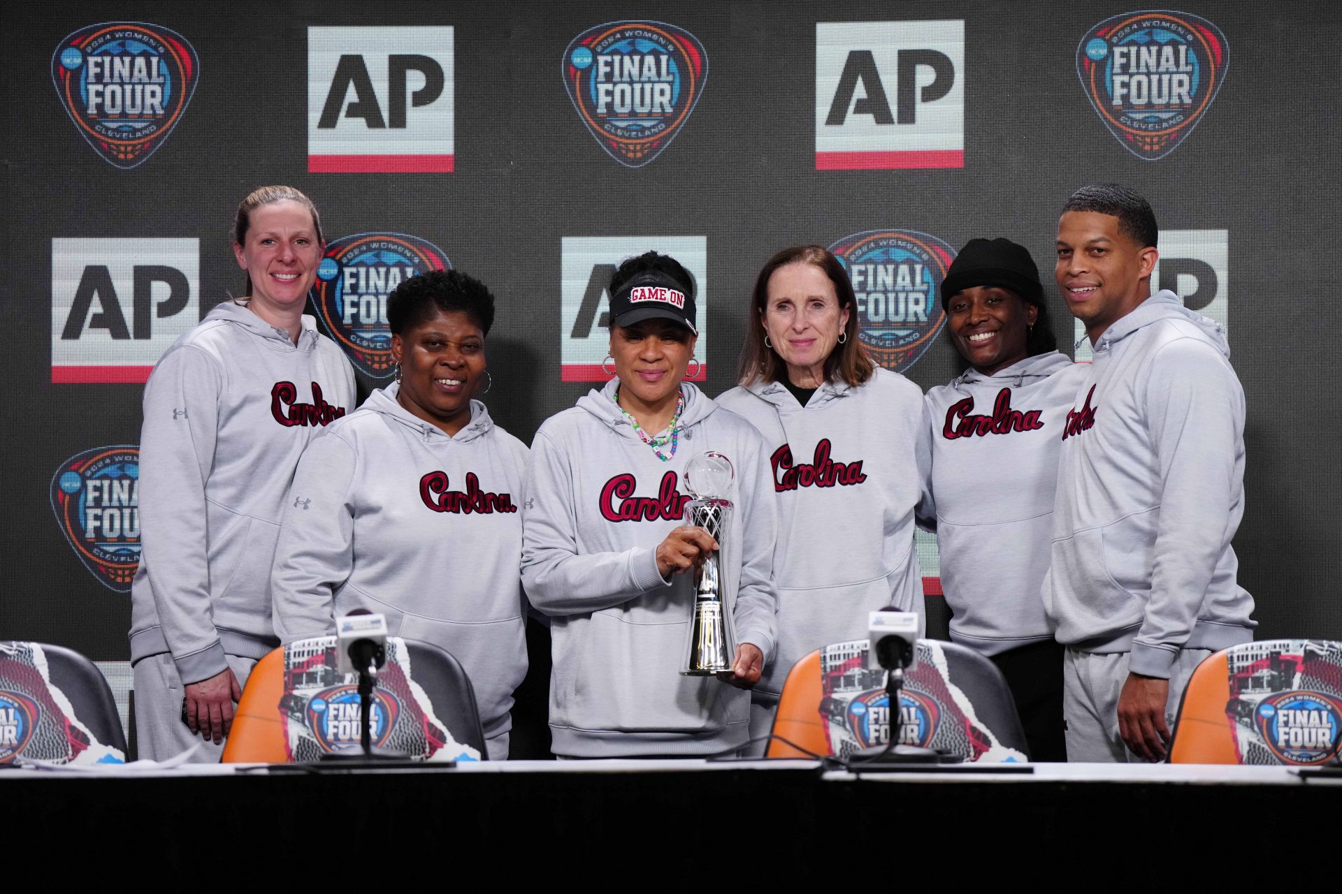 South Carolina Gamecocks coach Dawn Staley poses with staff after being named as the AP Coach of the Year at a press conference at Rocket Mortgage FieldHouse. From left: assistant coaches Mary Wooley and Jolette Law, Staley, associate head coach Lisa Boyer and assistant coaches Khadijah Sessions and Winston Gandy.