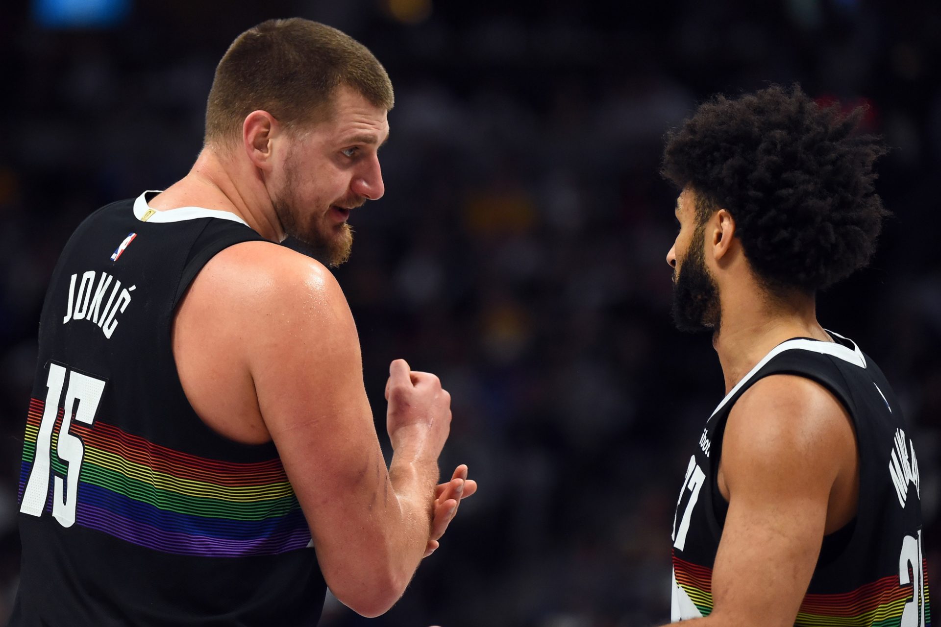 Denver Nuggets center Nikola Jokic (15) talks with guard Jamal Murray (27) during the first half at Ball Arena.
