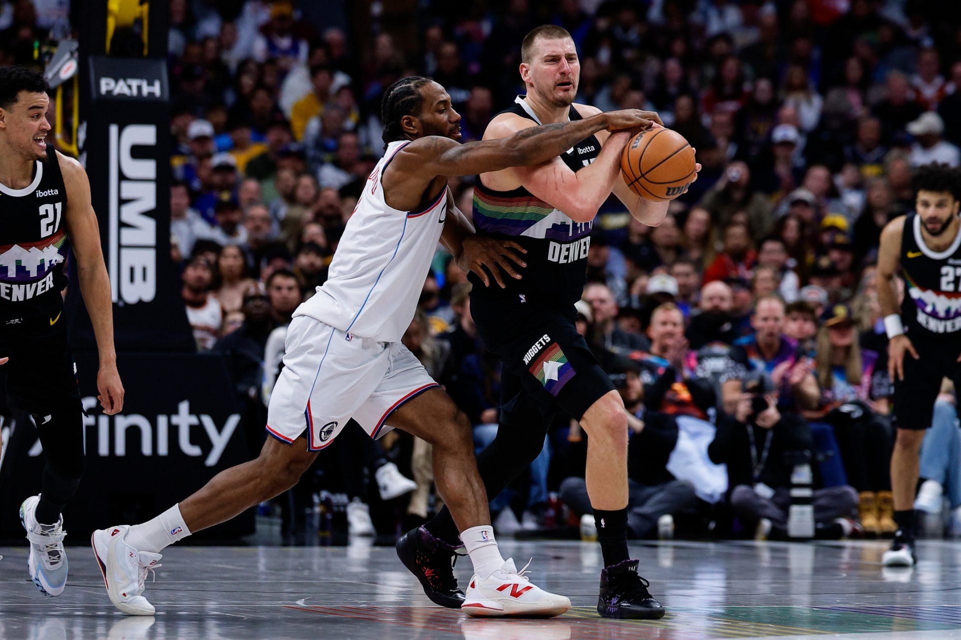 Denver Nuggets center Nikola Jokic (15) is fouled by Los Angeles Clippers forward Kawhi Leonard (2) in the third quarter at Ball Arena.