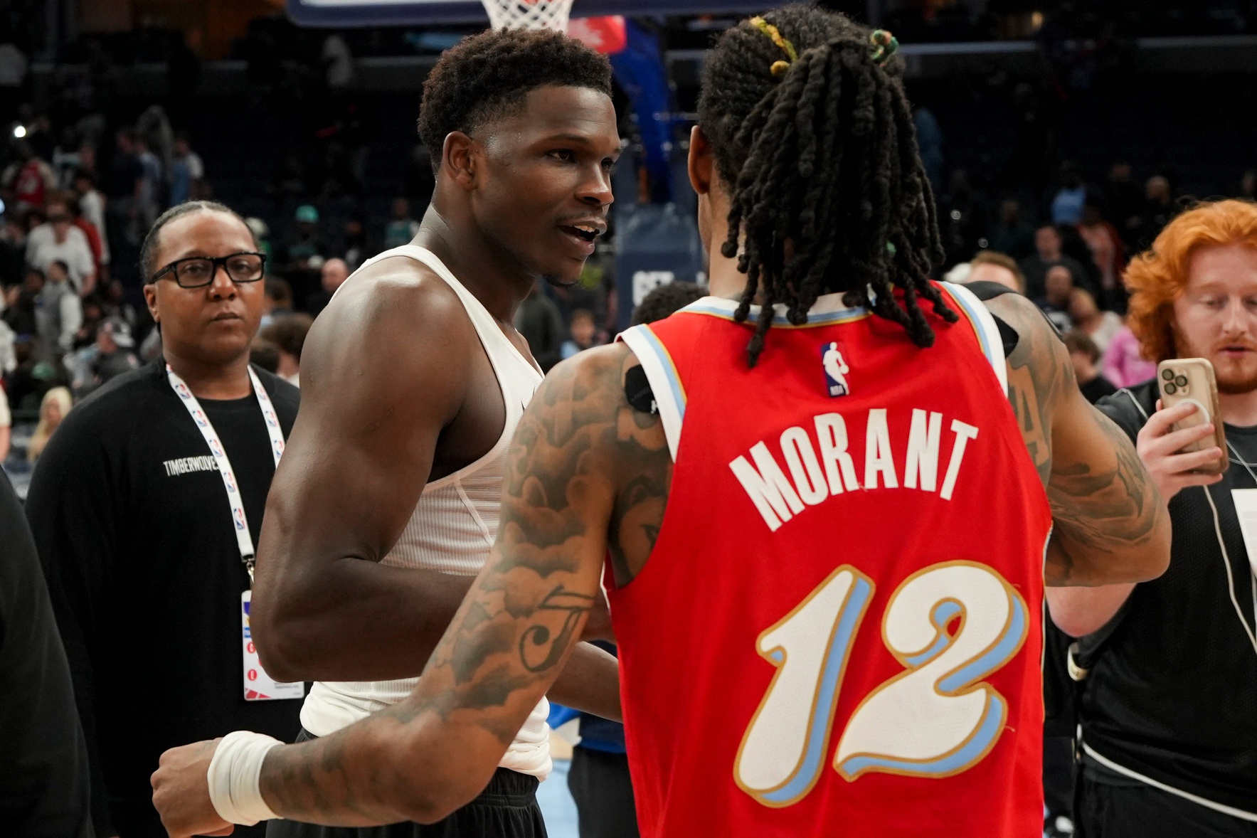 Timberwolves' Anthony Edwards (5) and Grizzlies' Ja Morant (12) hug after the Timberwolves defeated the Grizzlies 141-125 at FedExForum in Memphis, Tenn., on Thursday, April 10, 2025.