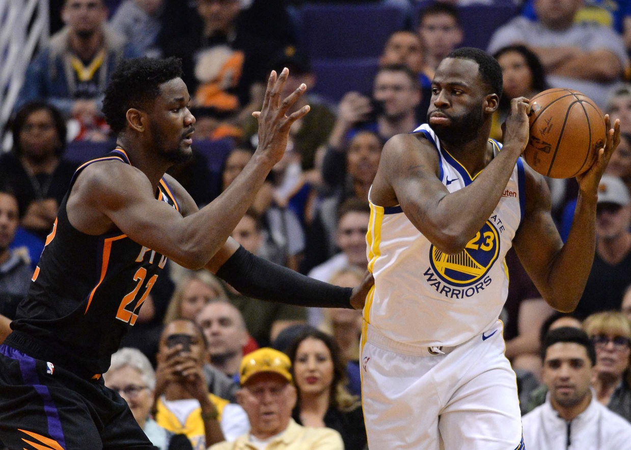 Phoenix Suns center Deandre Ayton (22) guards Golden State Warriors forward Draymond Green (23) during the first half at Talking Stick Resort Arena.