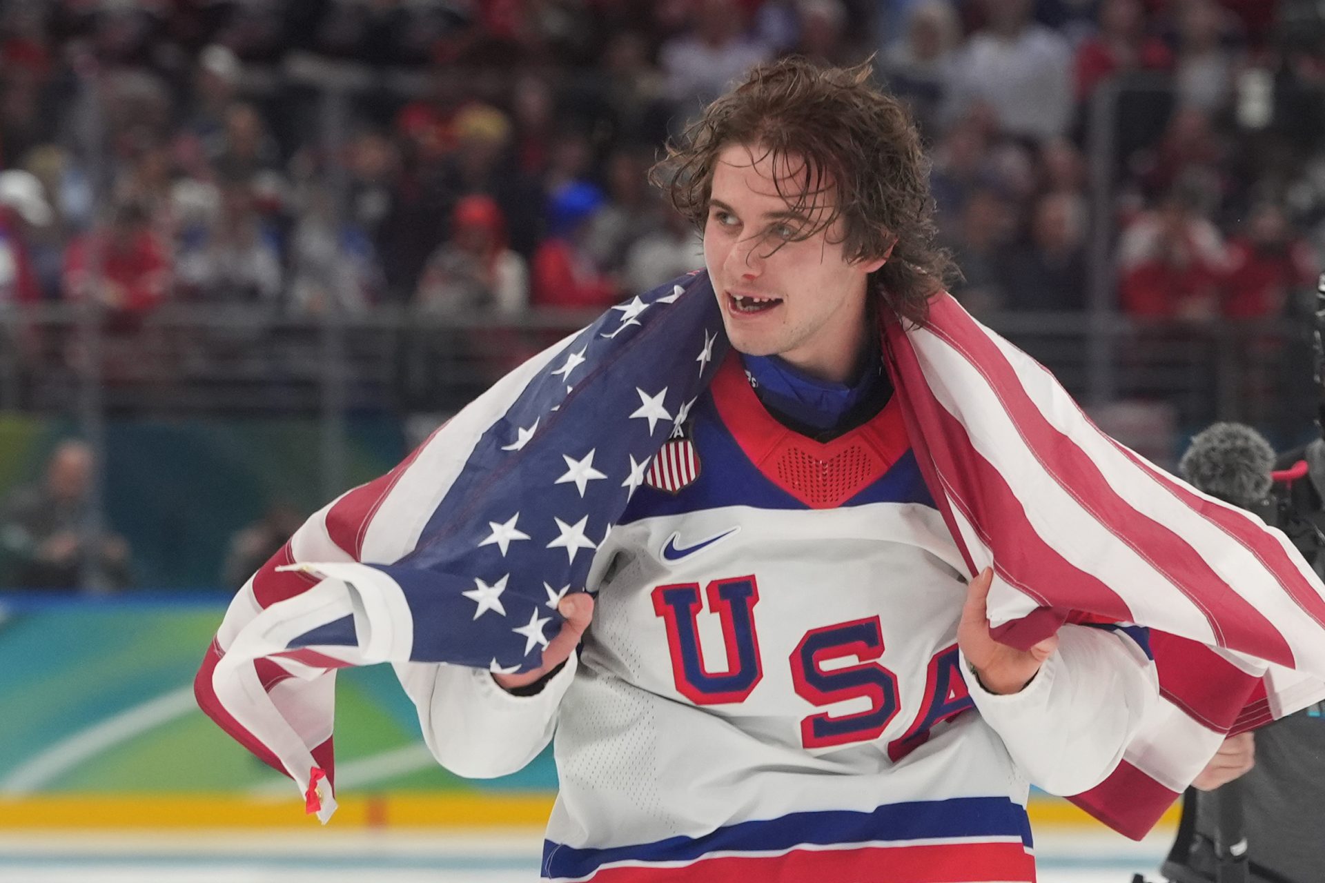 Jack Hughes (86) of the United States celebrates after defeating Canada in the men's ice hockey gold medal game during the Milano Cortina 2026 Olympic Winter Games at Milano Santagiulia Ice Hockey Arena.
