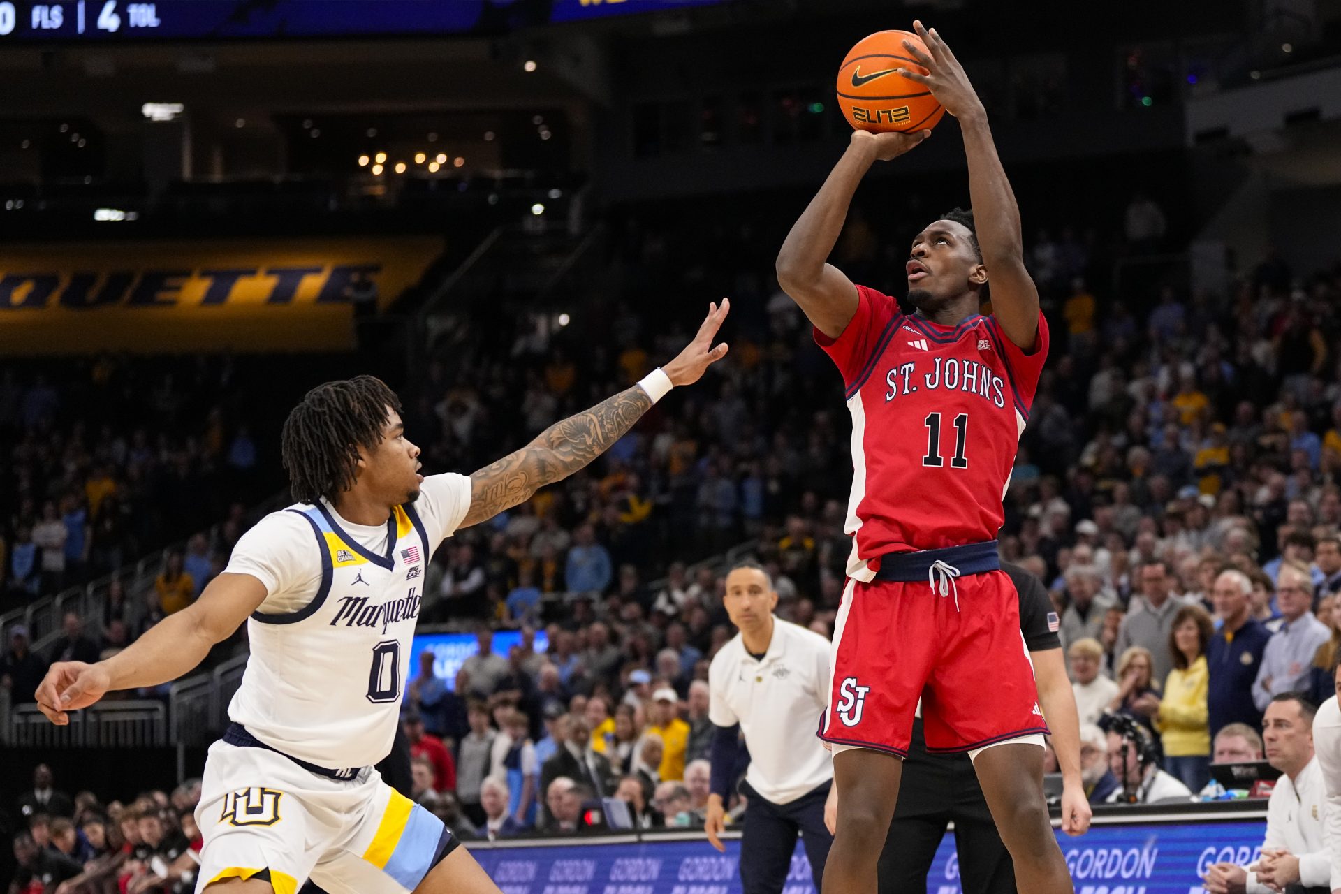 St. John’s Red Storm guard Ian Jackson (11) shoots over Marquette Golden Eagles guard Nigel James Jr. (0) during the first half at Fiserv Forum.