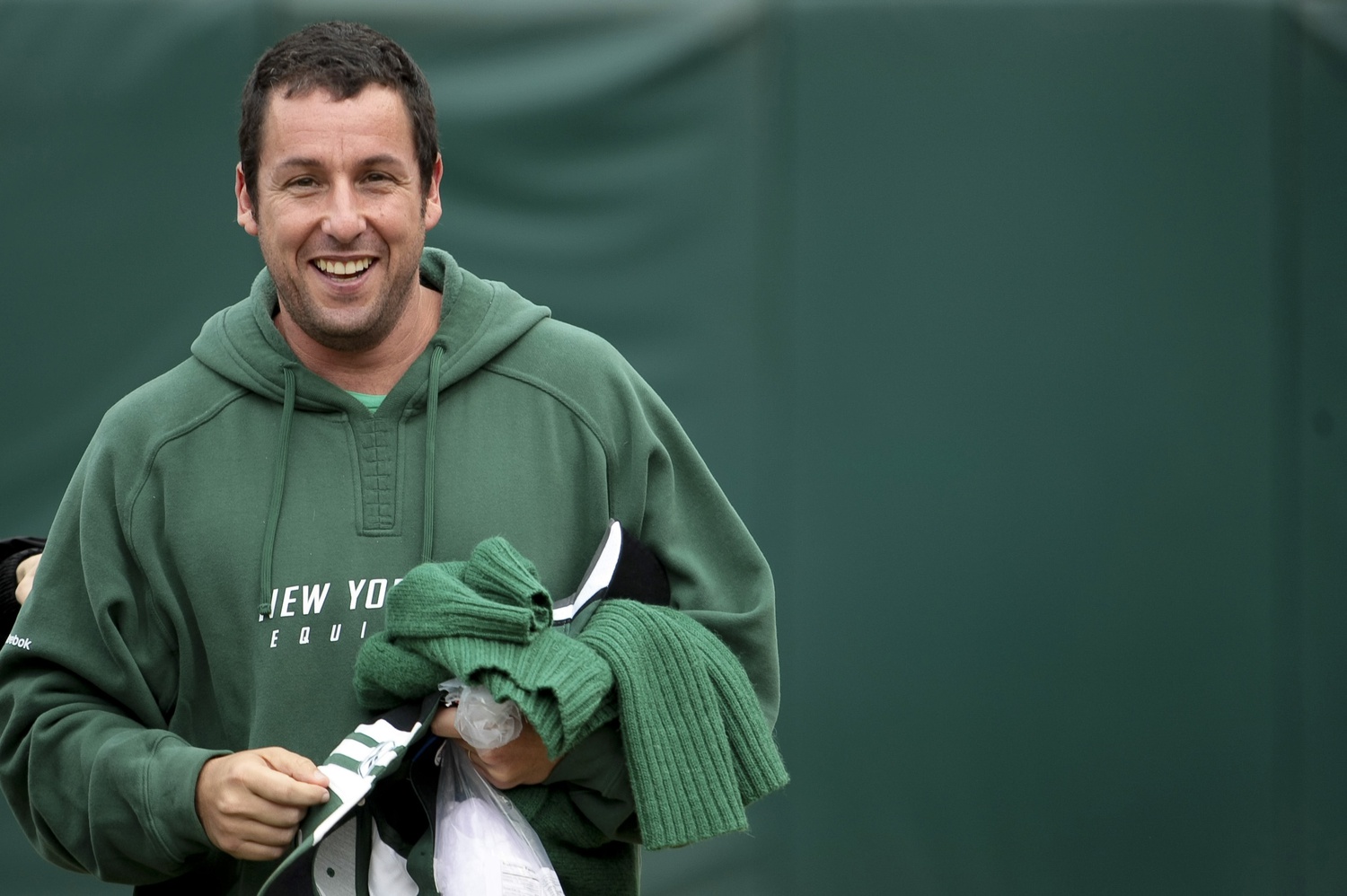 New York Jets fan, Adam Sandler leaves the field after the game against the Oakland Raiders at O.co Coliseum. The Oakland Raiders defeated the New York Jets 34-24.