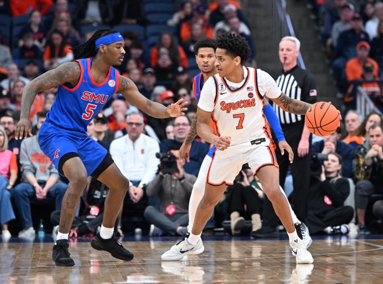 Syracuse Orange forward Kiyan Anthony (7) looks to get the ball past Southern Methodist University Mustangs guard Jaron Pierre Jr. (5) in the first half  at the JMA Wireless Dome.