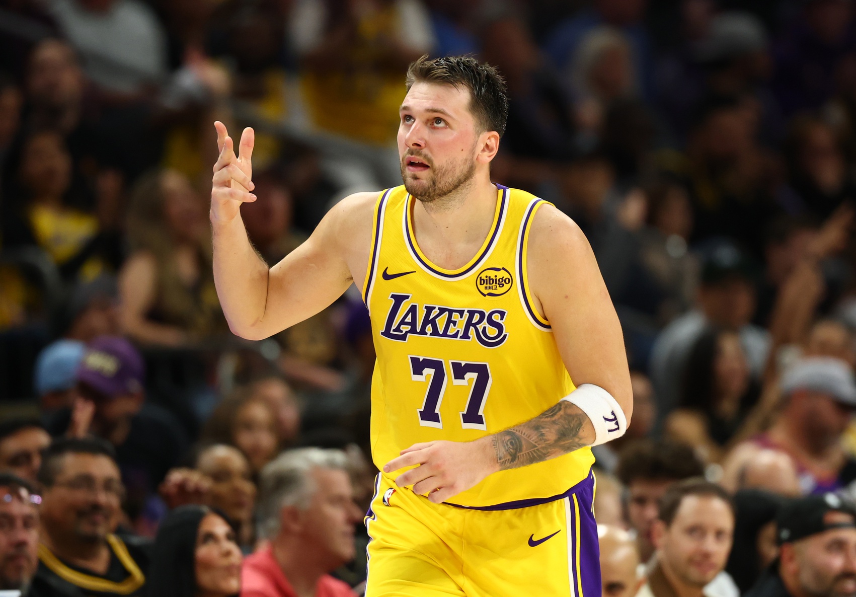 Los Angeles Lakers guard Luka Doncic (77) celebrates a three point shot against the Phoenix Suns in the first half at Mortgage Matchup Center - Source: Imagn Images