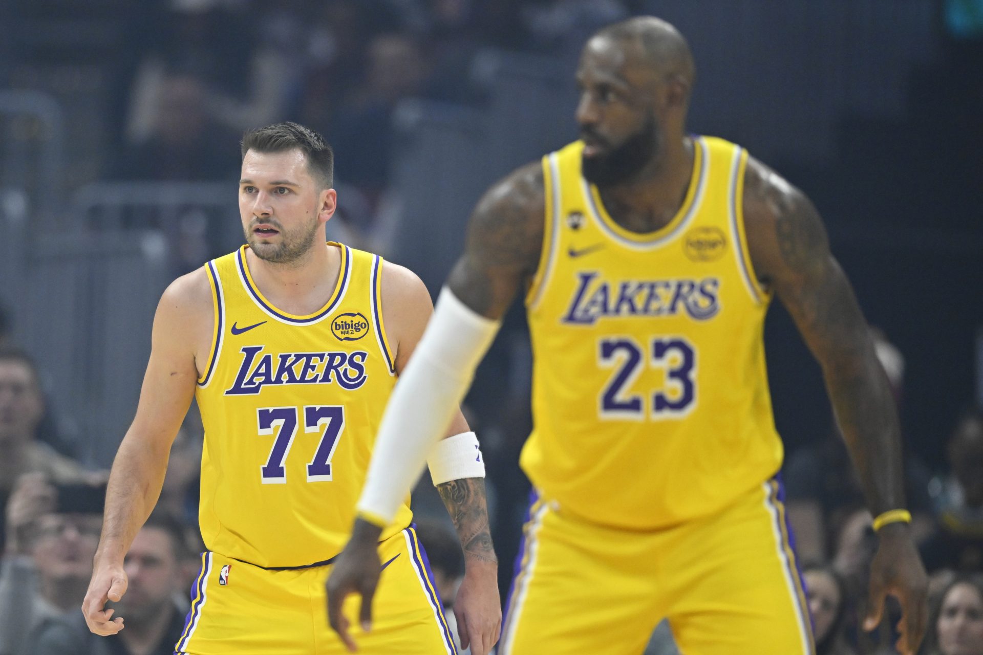 Los Angeles Lakers guard Luka Doncic (77) and forward LeBron James (23) stand on the court in the first quarter against the Cleveland Cavaliers at Rocket Arena - Source - Imagn Images