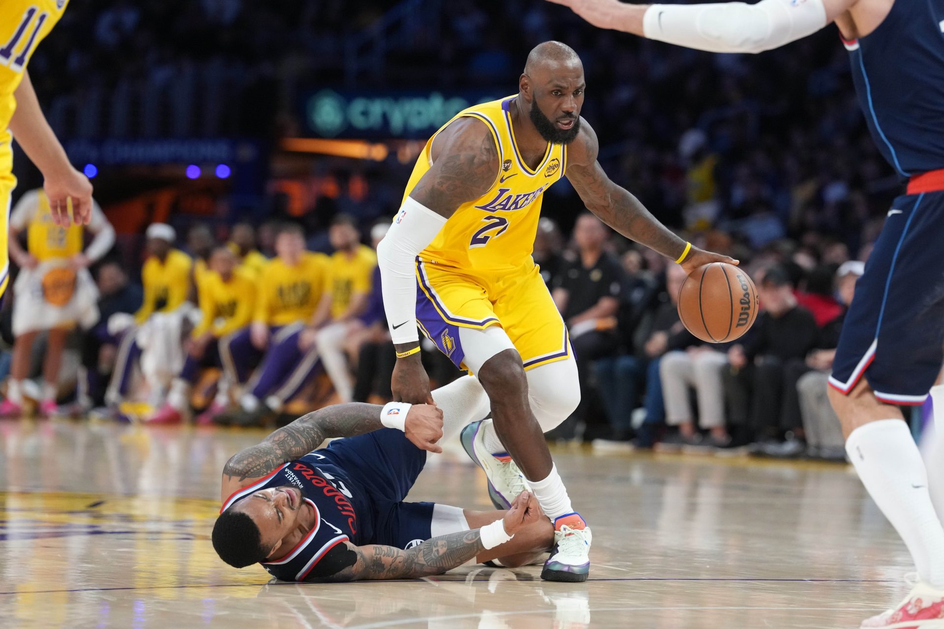 Los Angeles Lakers forward LeBron James (23) dribbles the ball against LA Clippers forward John Collins (20) in the first half at Crypto.com Arena.