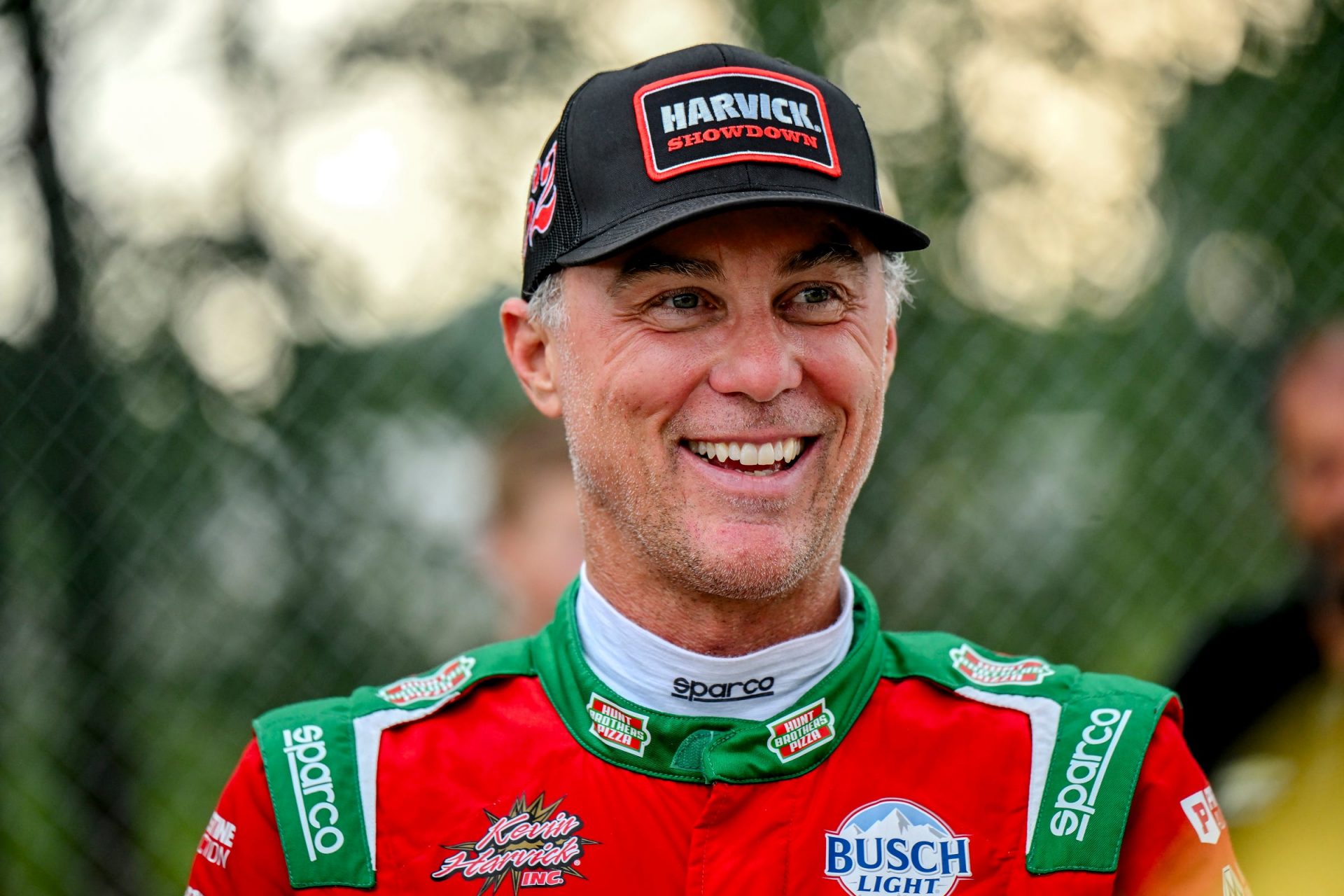 Former NASCAR Cup Series champion Kevin Harvick smiles during an autograph session before the 13th annual Masters of the Pros 200 race on Wednesday, July 16, 2025, at Owosso Speedway. Harvick and his 13-year-old son Keelan competed against each other in the race later in the night.