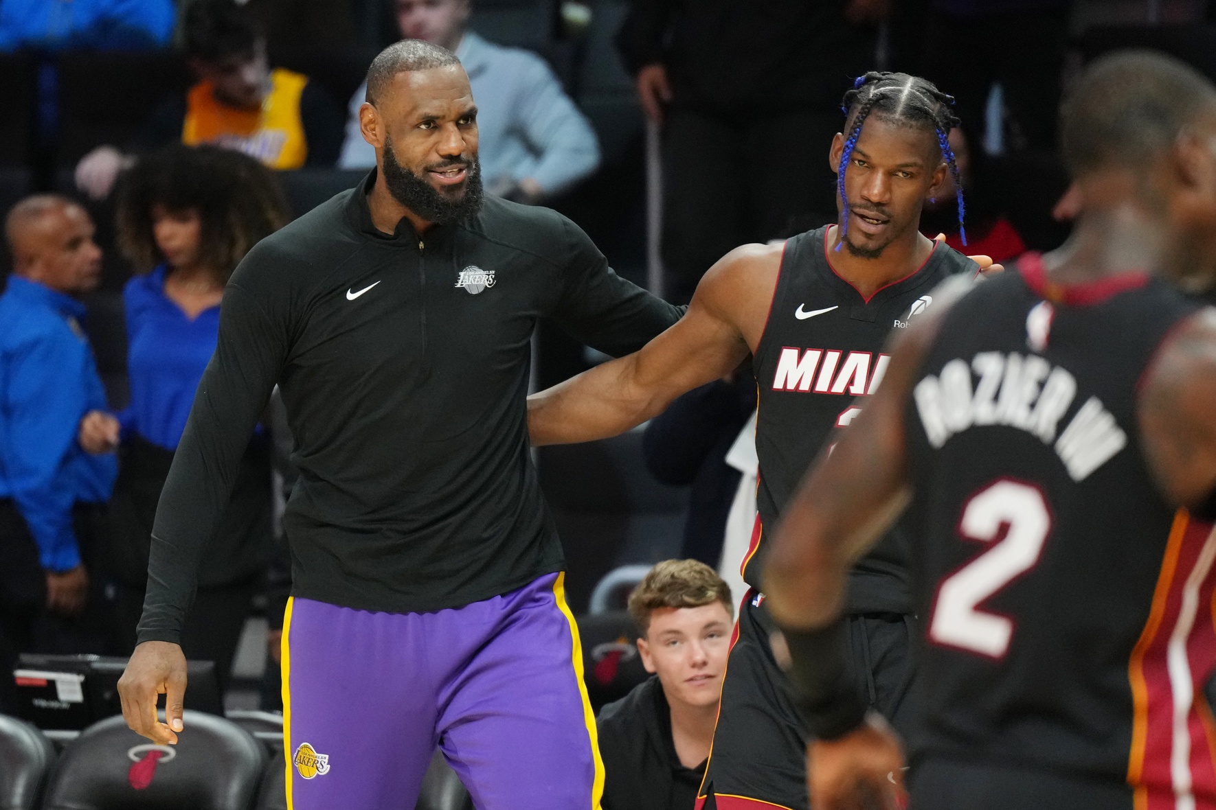 Los Angeles Lakers forward LeBron James (23) and Miami Heat forward Jimmy Butler (22) greet each other following the game at the Kaseya Center.