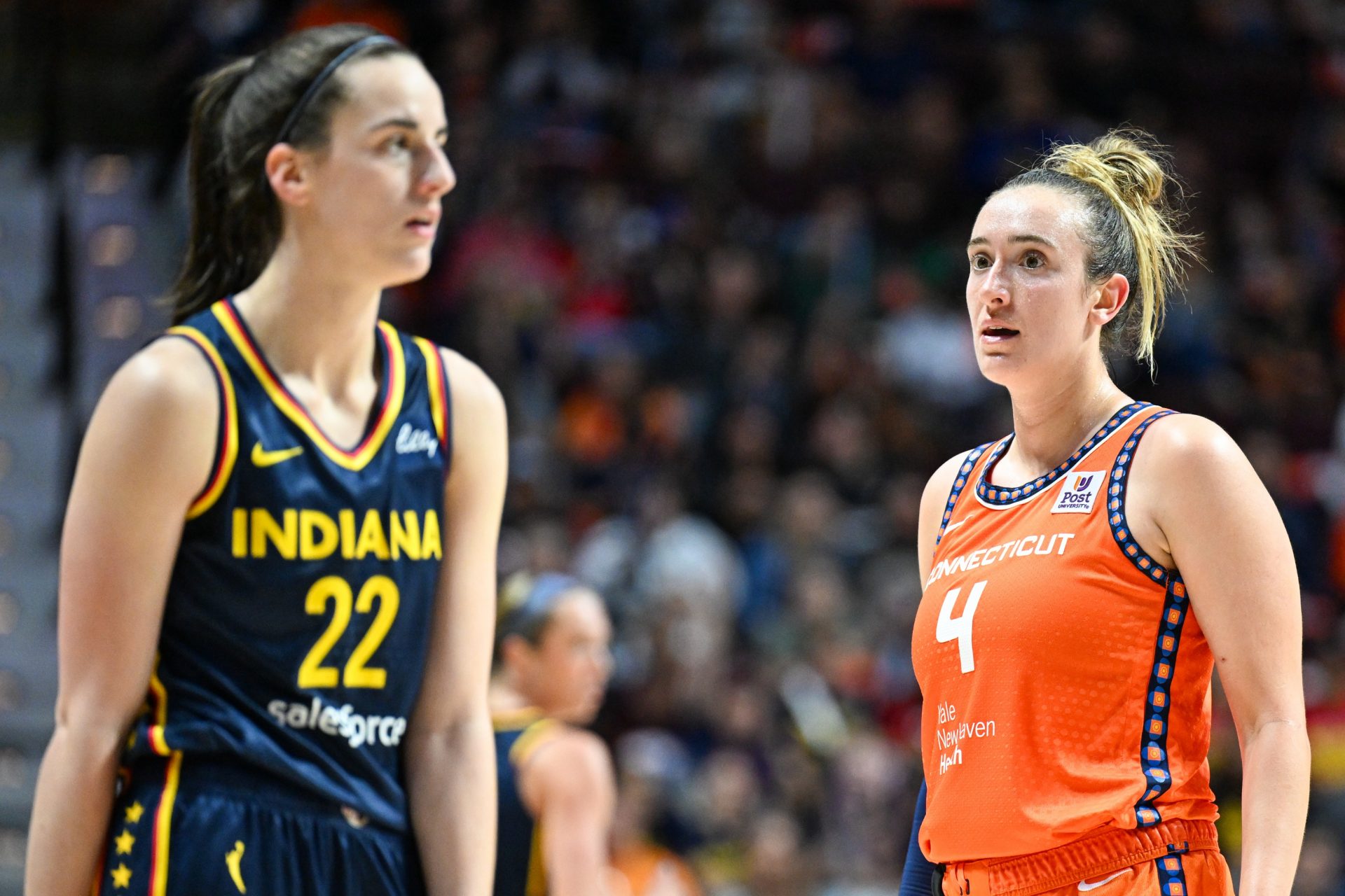 Connecticut Sun guard Marina Mabrey (4) stares at Indiana Fever guard Caitlin Clark (22) in the third quarter during game one of the first round of the 2024 WNBA Playoffs at Mohegan Sun Arena.