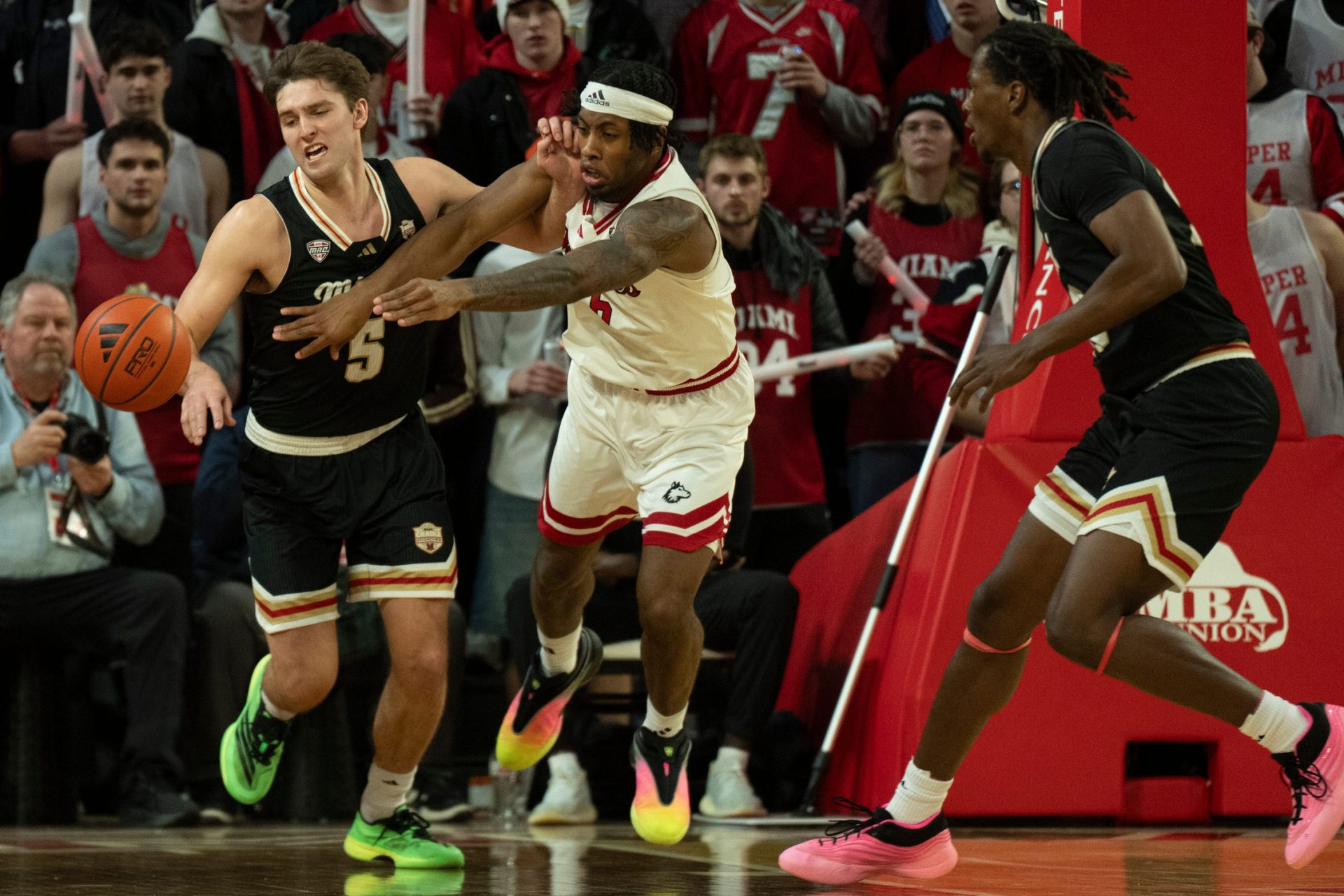 Miami RedHawks guard Peter Suder (5) makes a steal on Northern Illinois Huskies guard Taj Walters (6) in the second half of the NCAA Basketball game at Millett Hall in Oxford, Ohio, on Saturday, January 31, 2026.